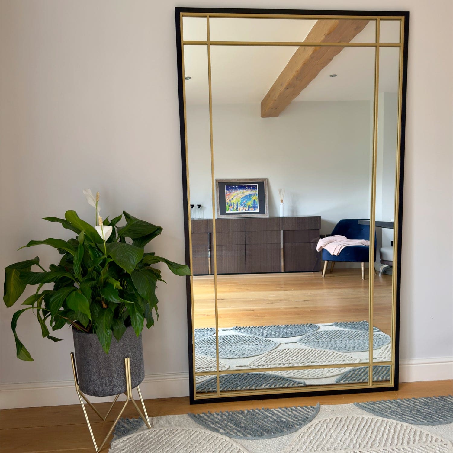 Rectangular black and gold framed mirror.