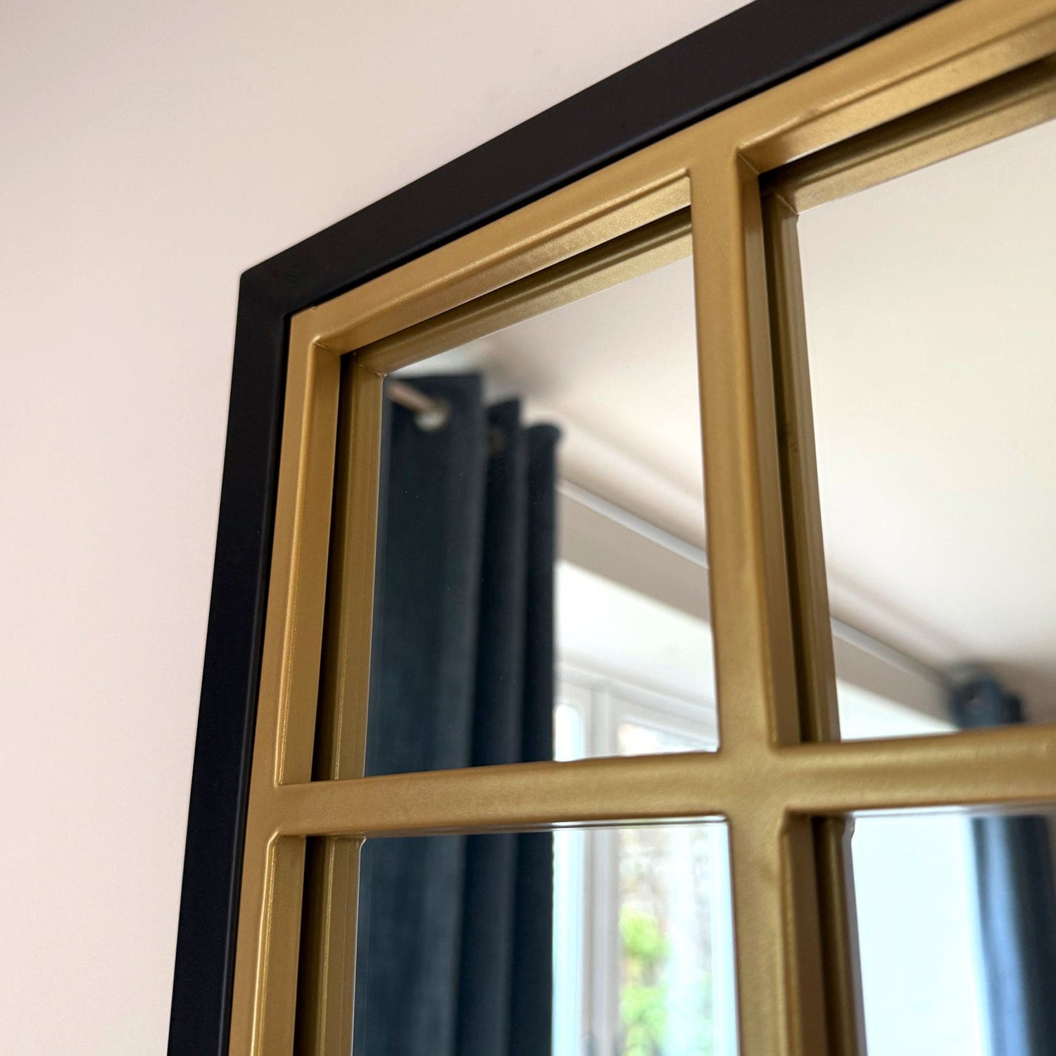 Black and gold windowpane mirror.