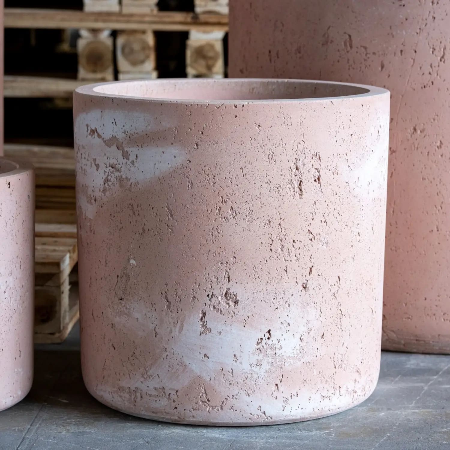Cylindrical pink concrete planter.
