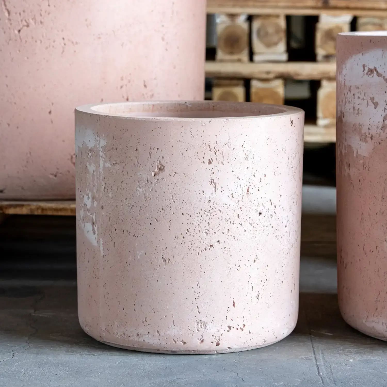 Pink concrete cylindrical planter.