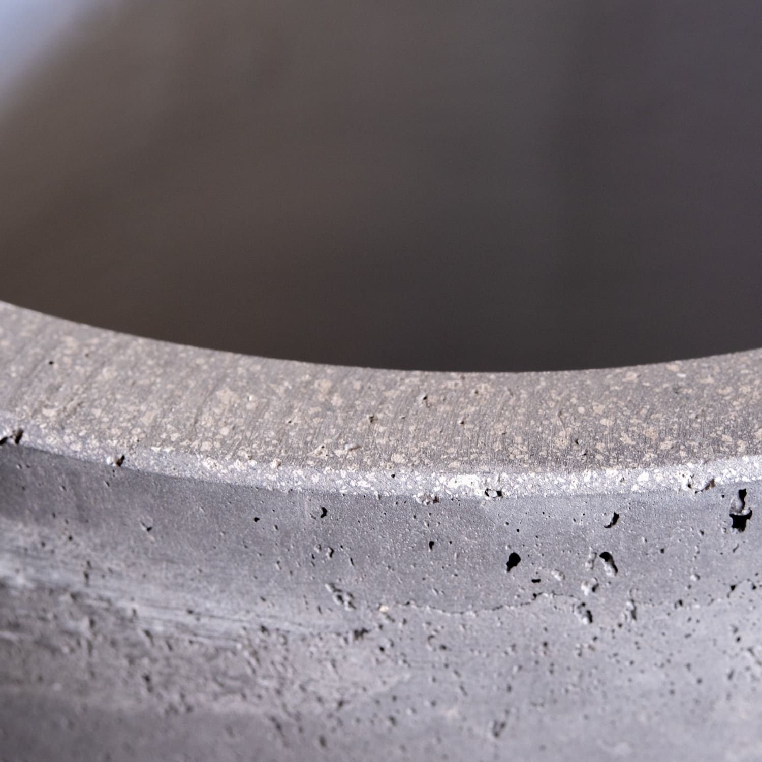 Textured gray concrete container rim.
