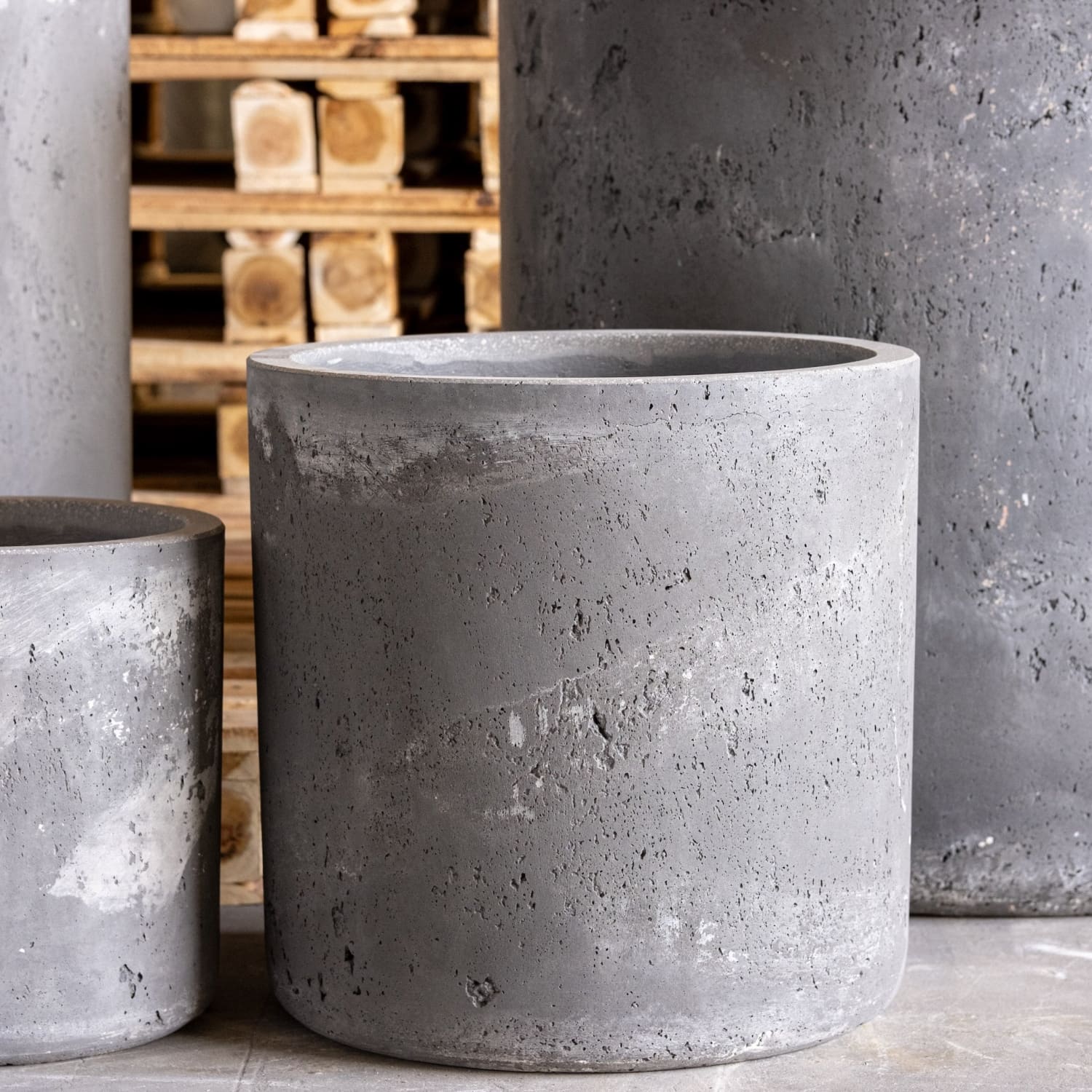 Gray concrete cylindrical planters.