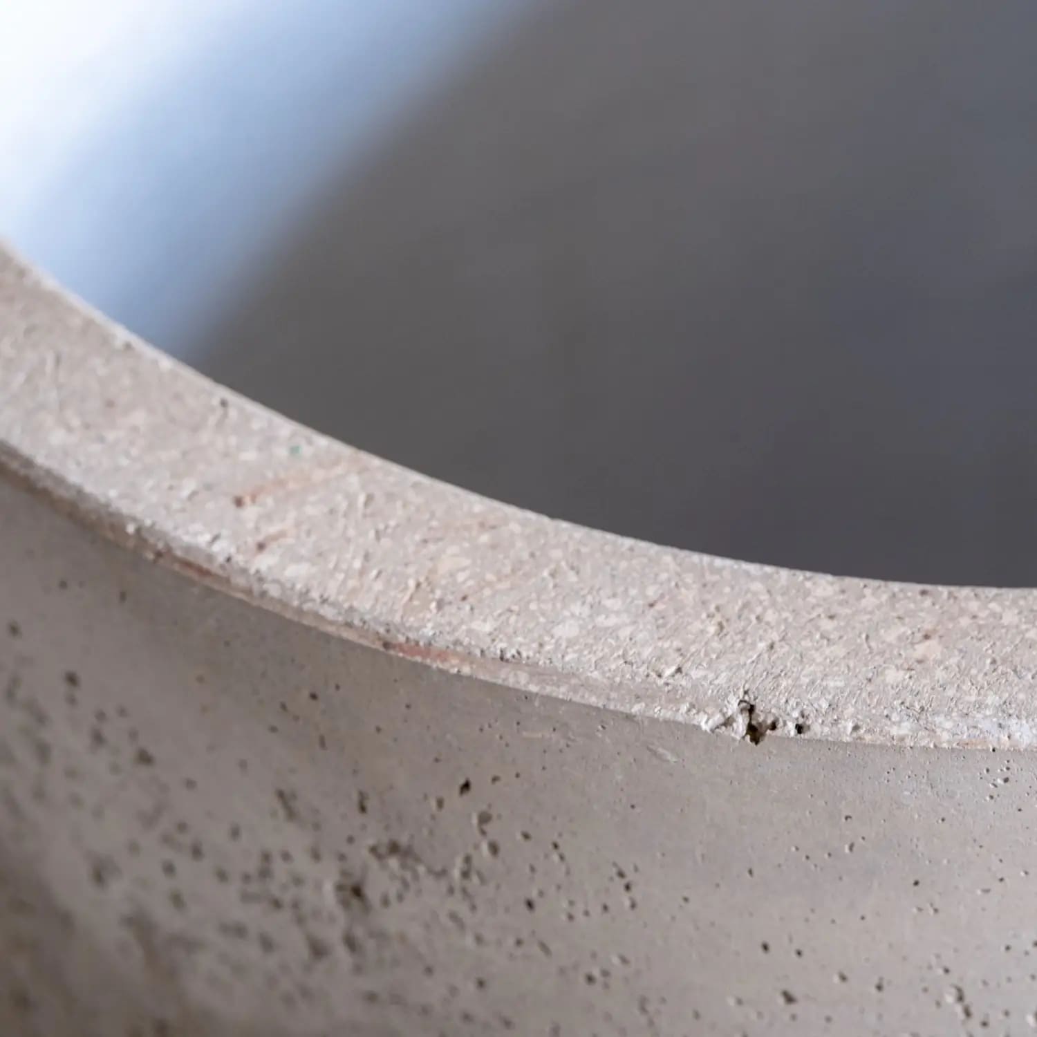 Textured concrete planter rim.