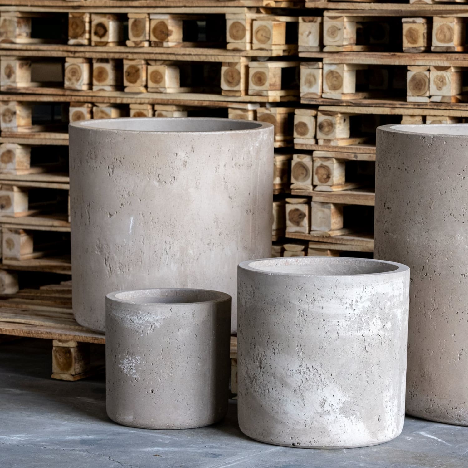 Four cylindrical concrete planters.