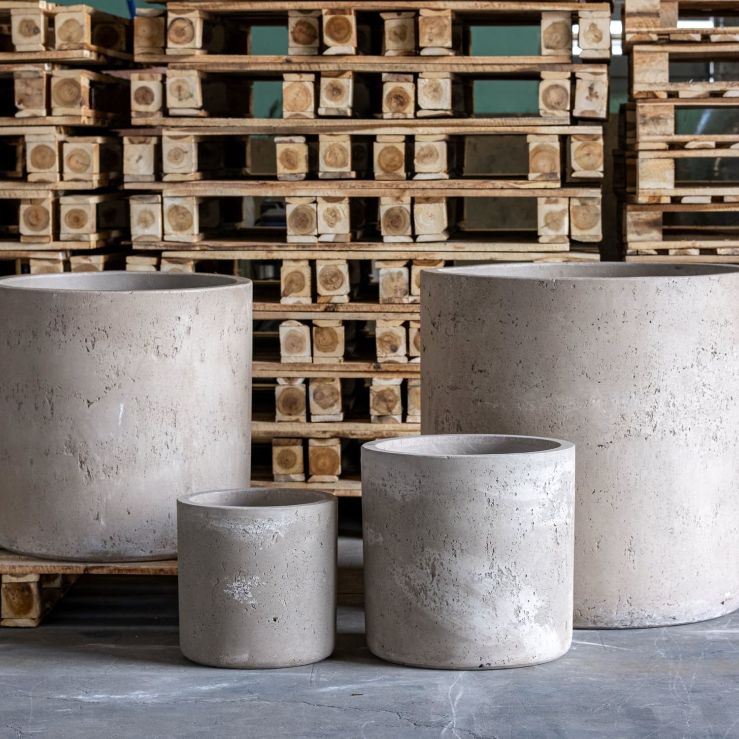 Four cylindrical concrete planters.