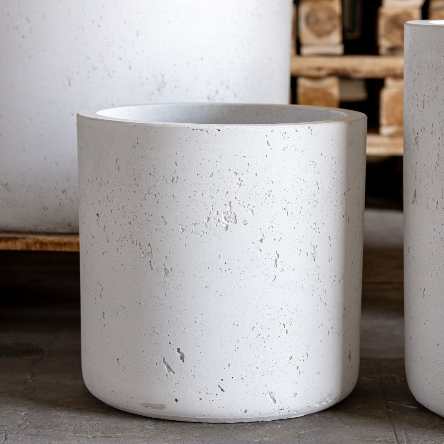 Cylindrical white concrete planter.