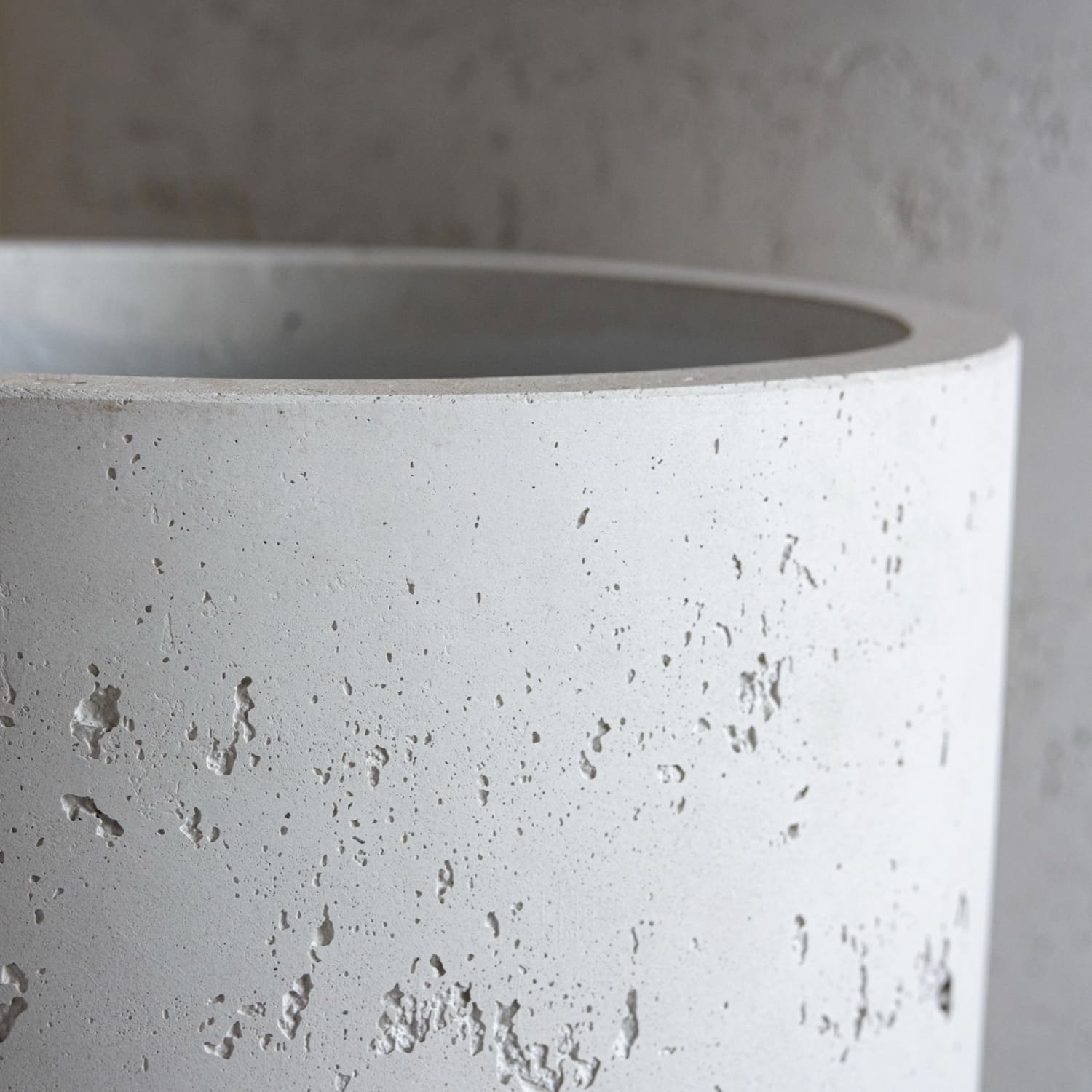 Textured cylindrical concrete planter.