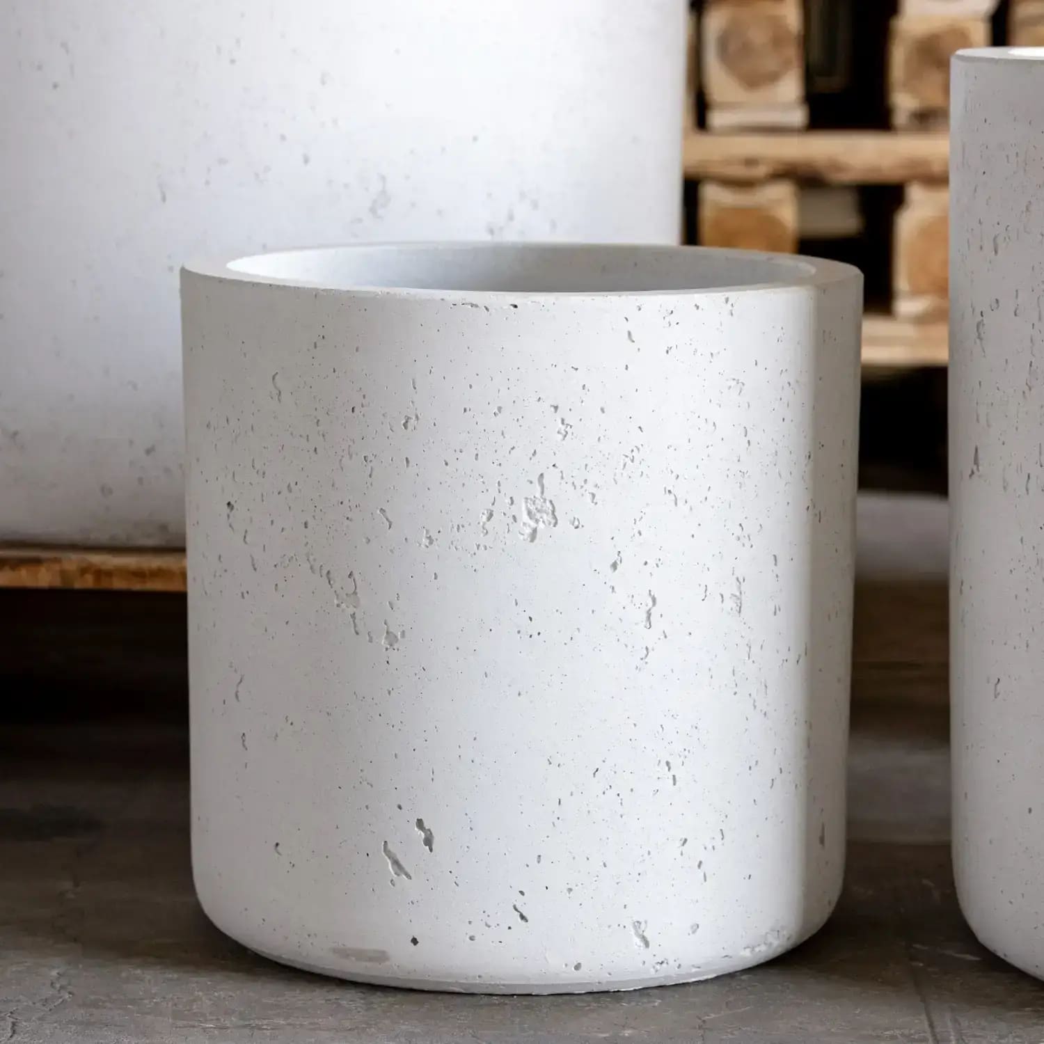 White cylindrical concrete planter.