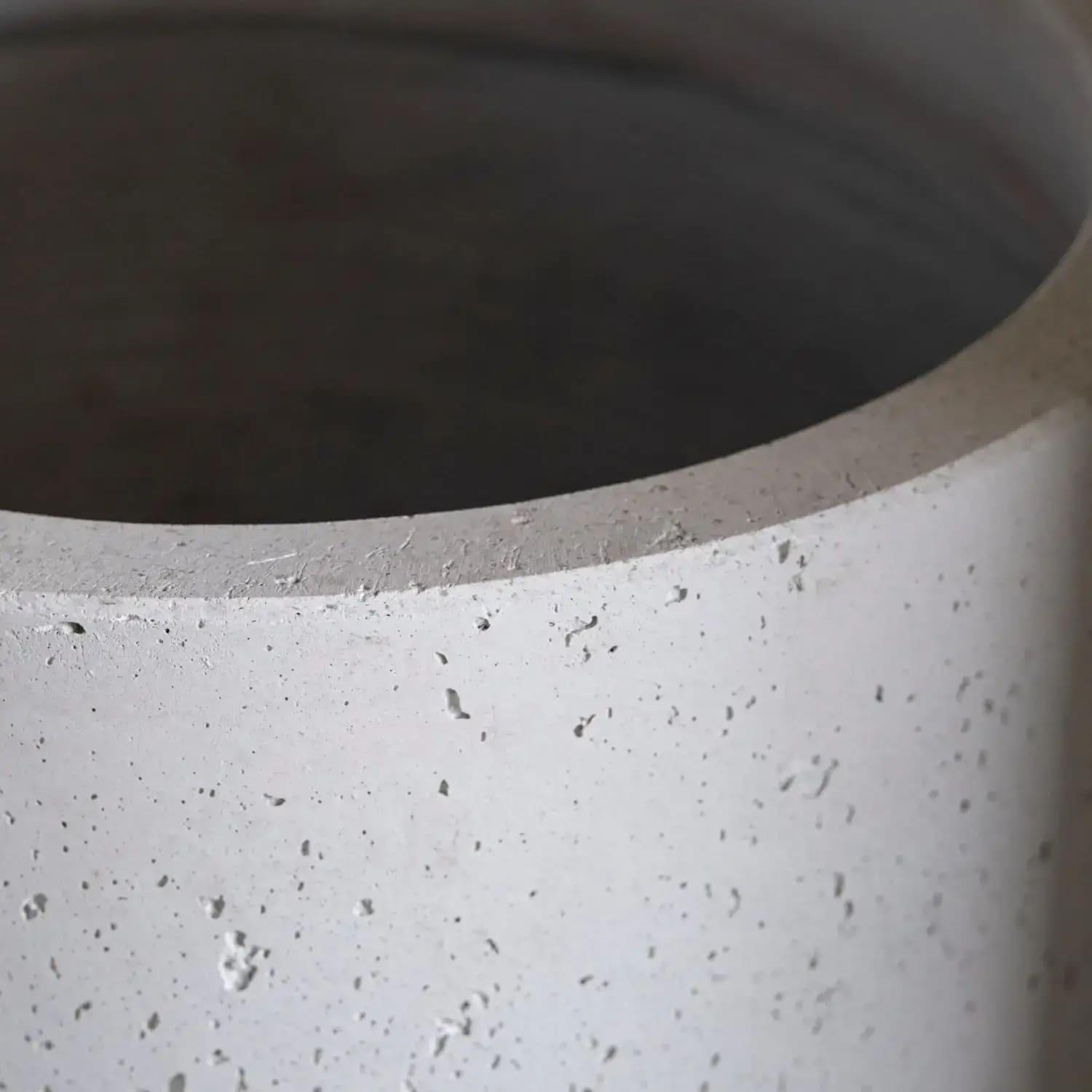Textured gray concrete cylinder.