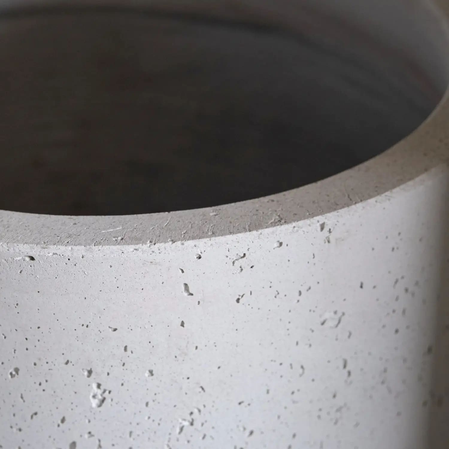 Gray concrete cylinder.