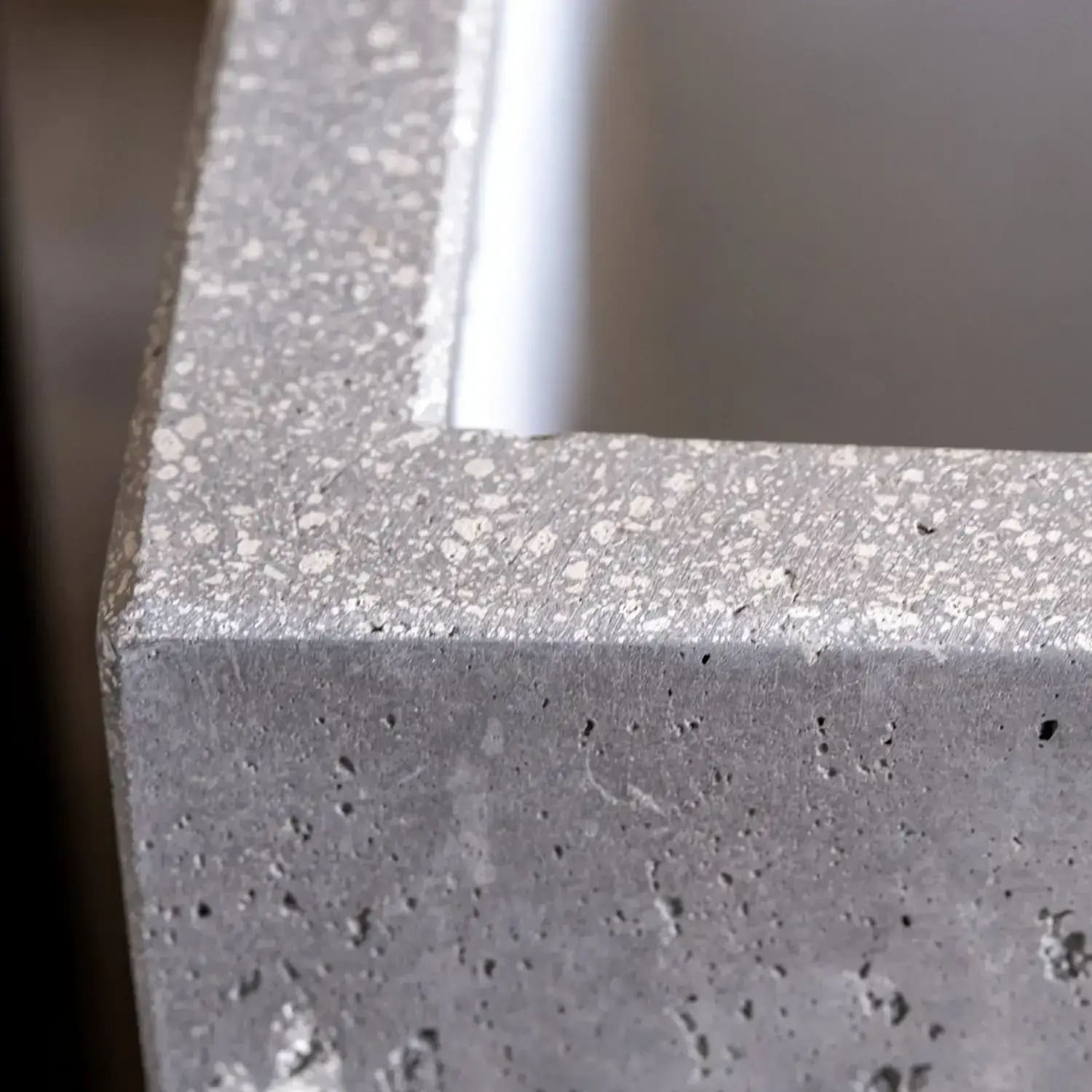 Concrete planter with terrazzo trim.