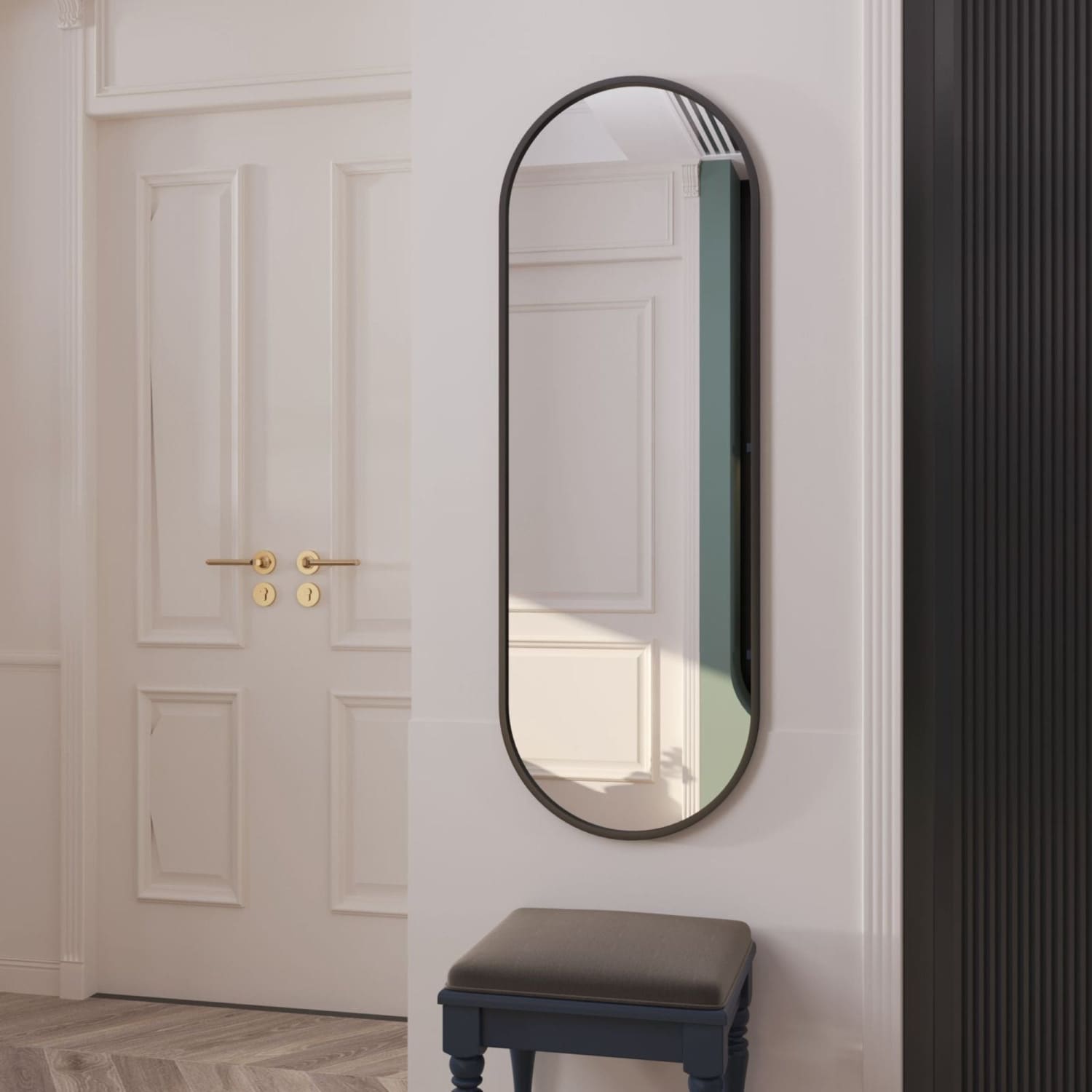 Oval-shaped mirror with a thin black metal frame.