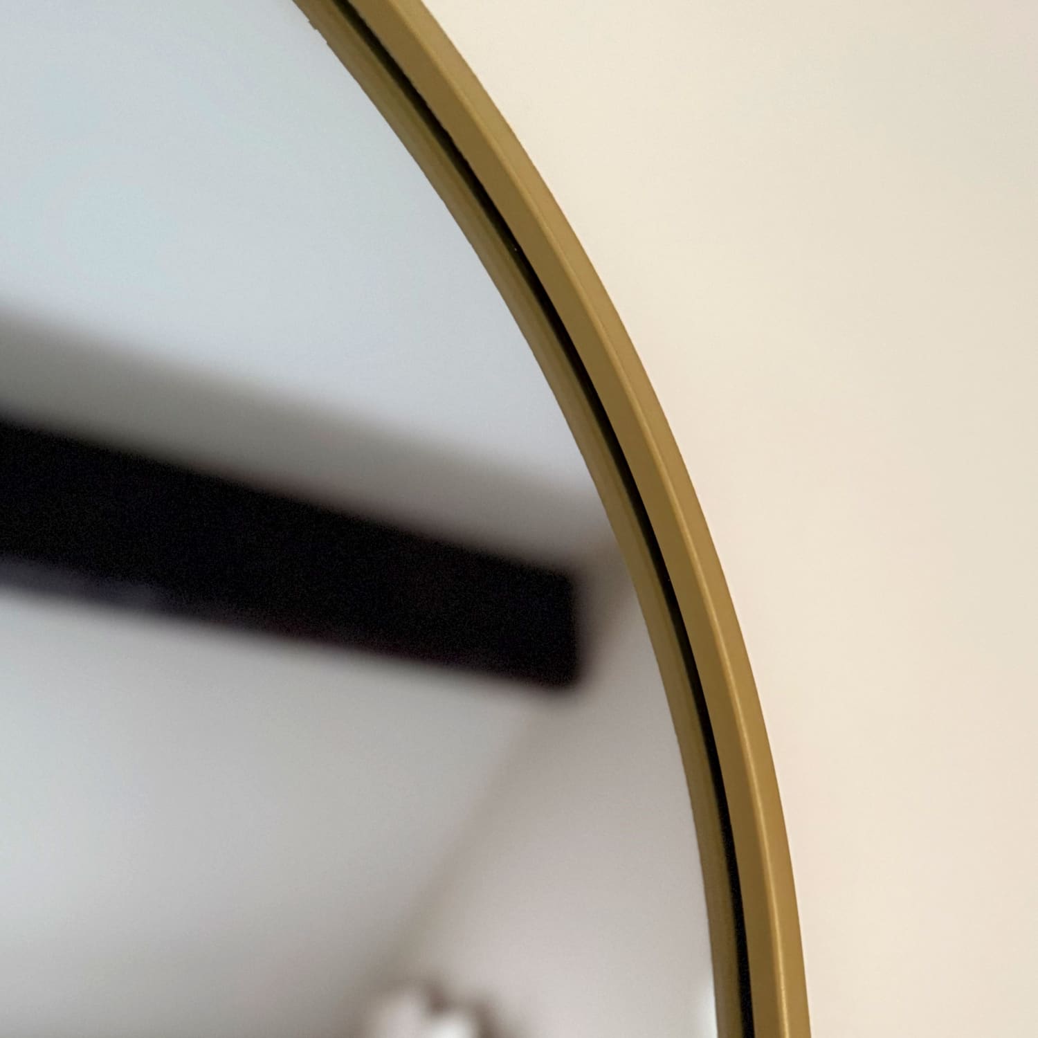 Circular gold-framed mirror.