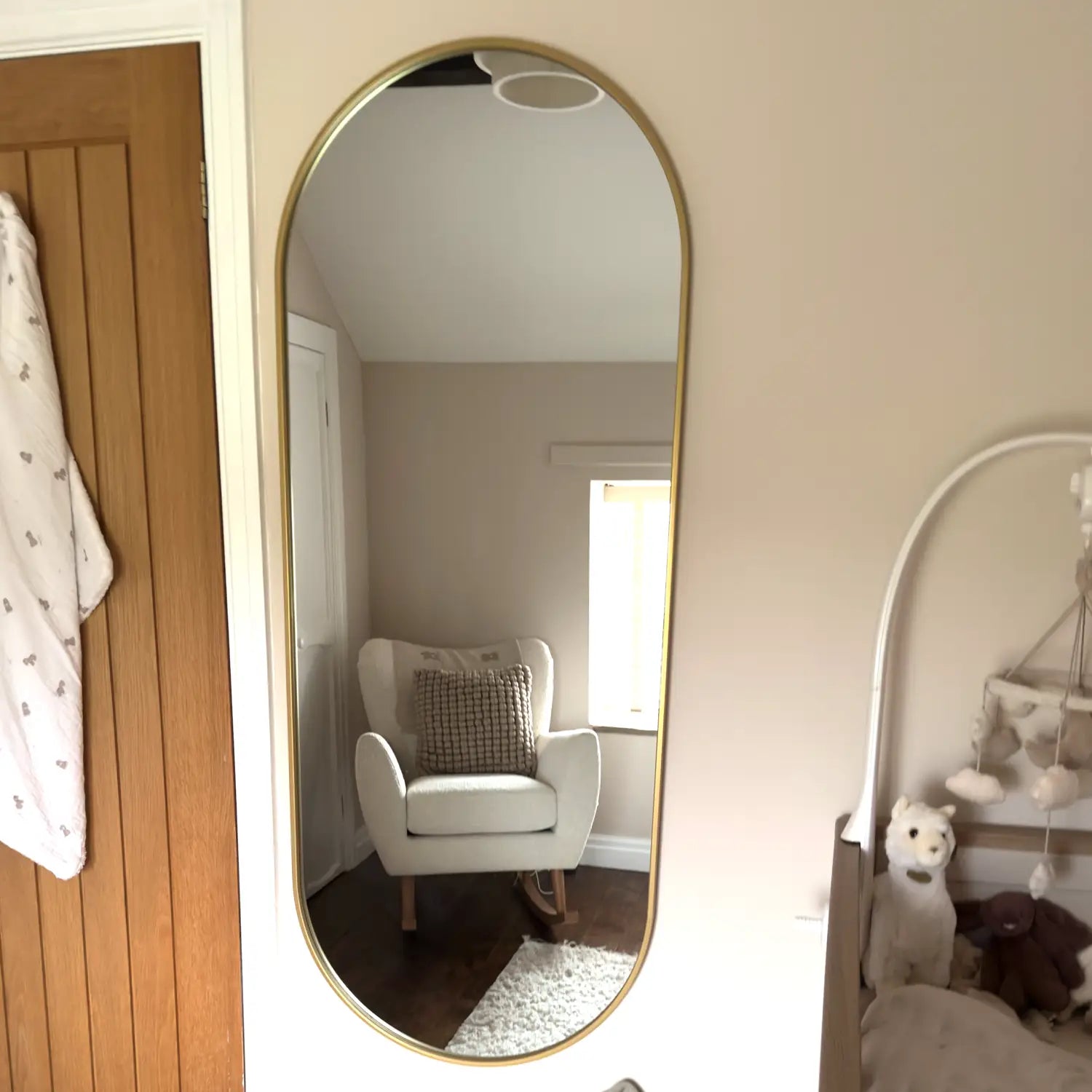 Tall, gold-framed mirror.