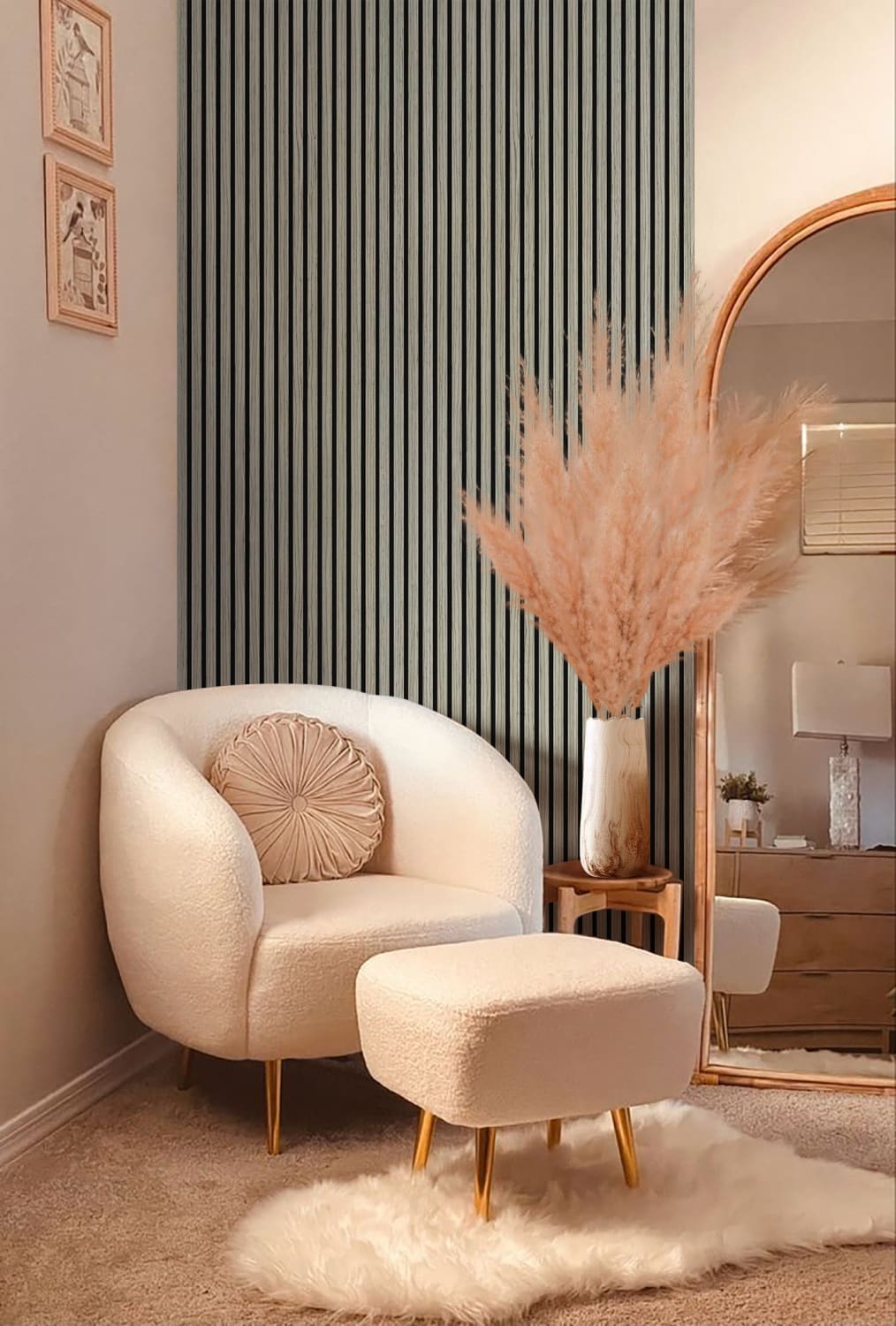 Cream-colored upholstered armchair with matching ottoman on gold legs.