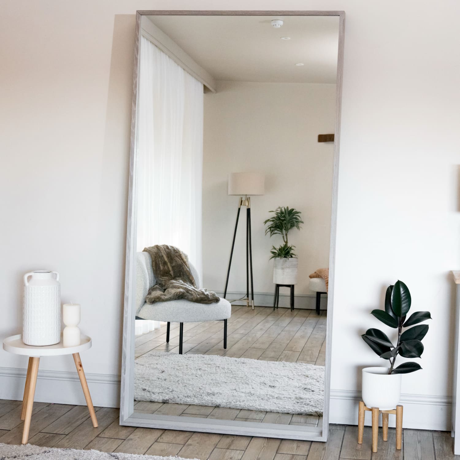 Floor-length mirror with a slim silver frame.
