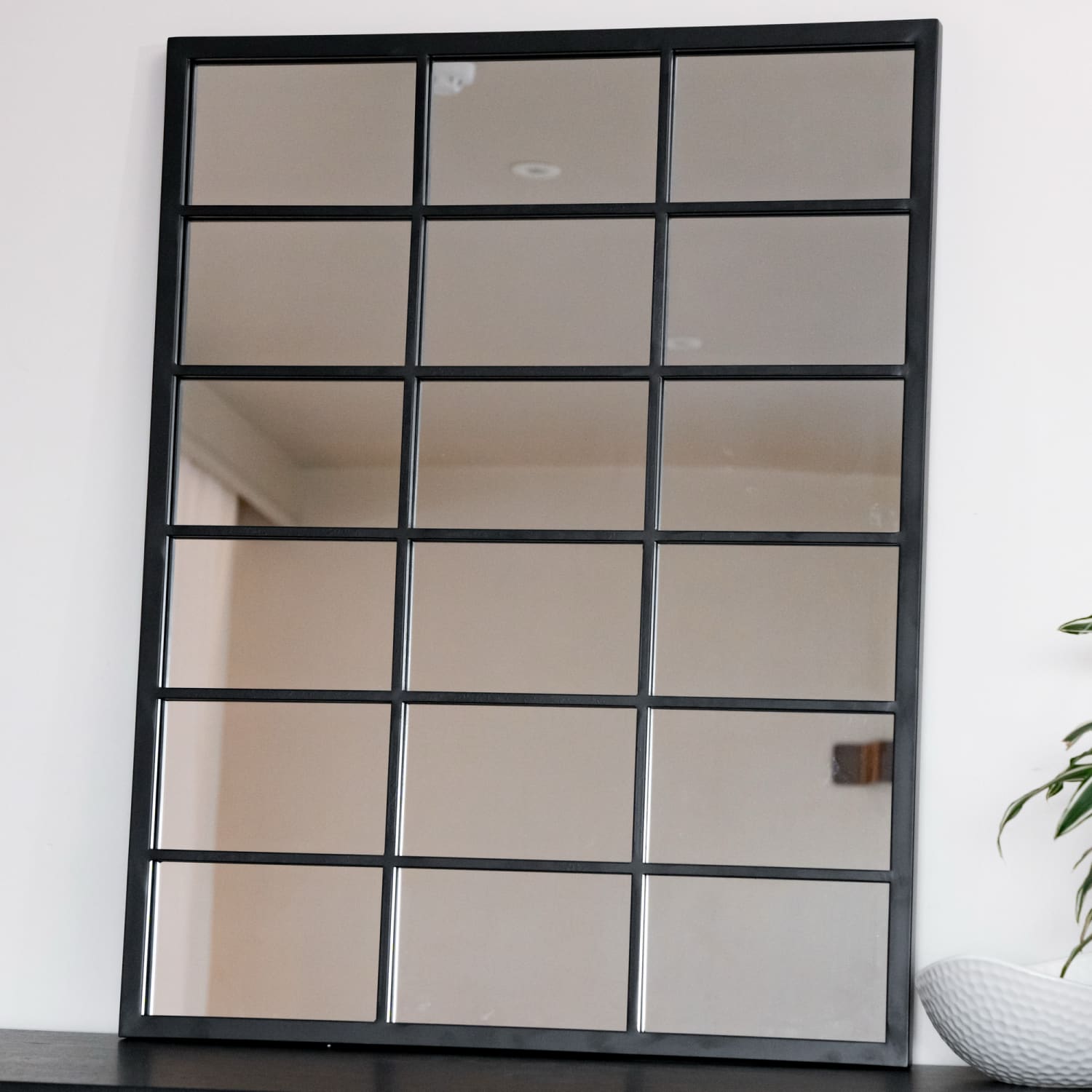 Black-framed window-pane style mirror with 18 rectangular sections.