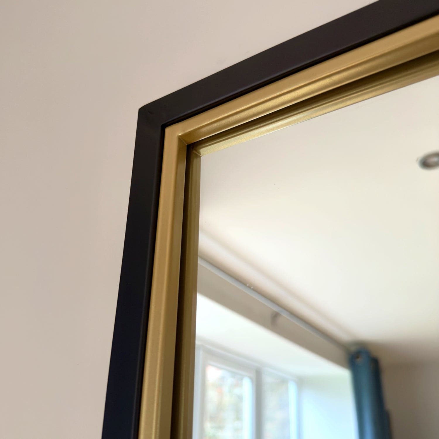 Black and gold framed mirror.
