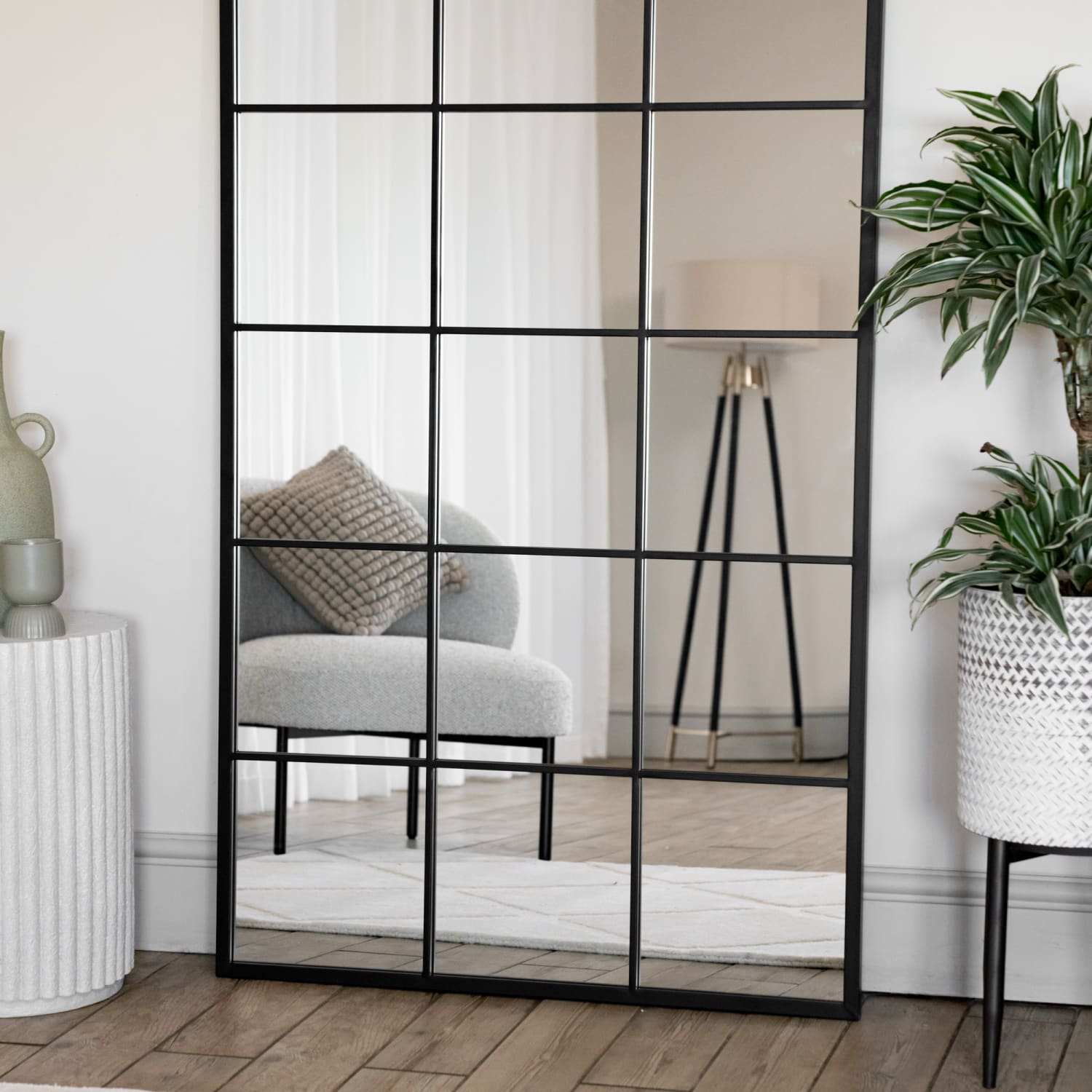 Black-framed window-pane style mirror with a grid pattern.