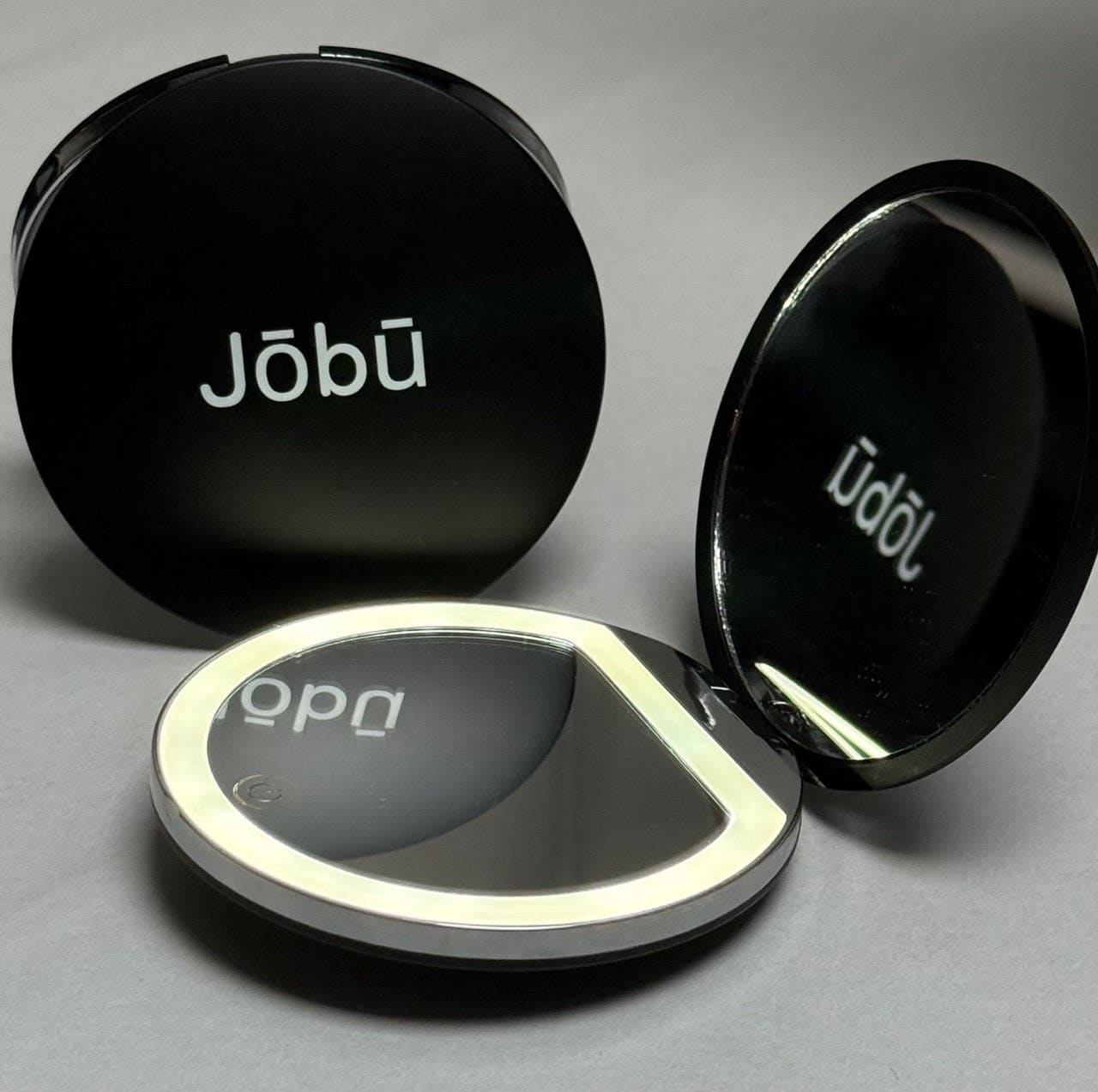Black compact mirror with illuminated edge, jobu brand.