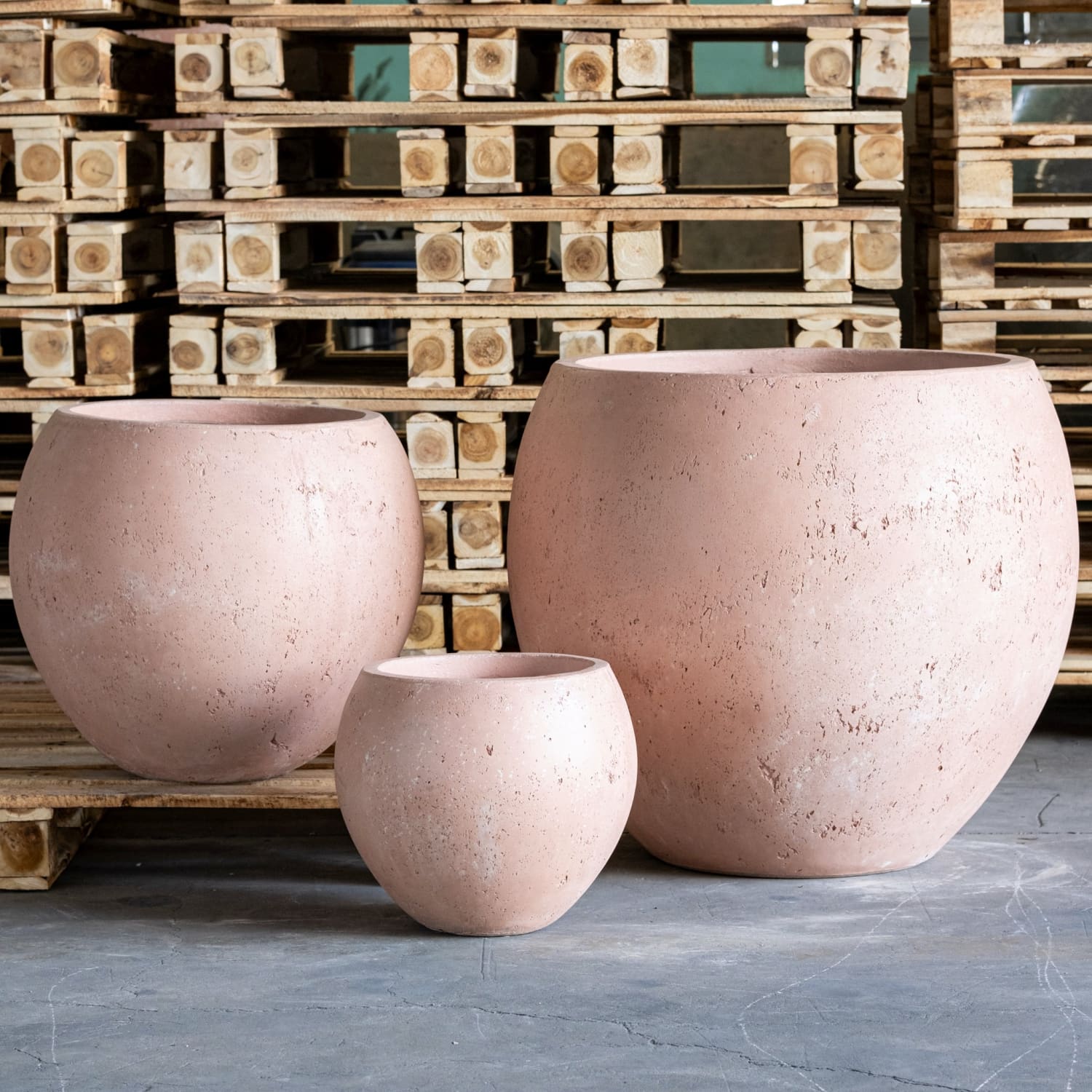 Three round, textured, pinkish-tan planters.