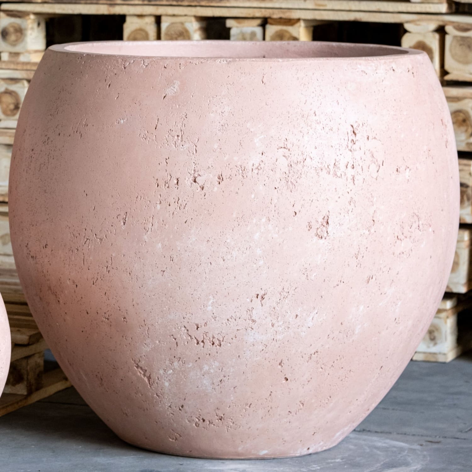 Round, textured, pinkish-tan pot.