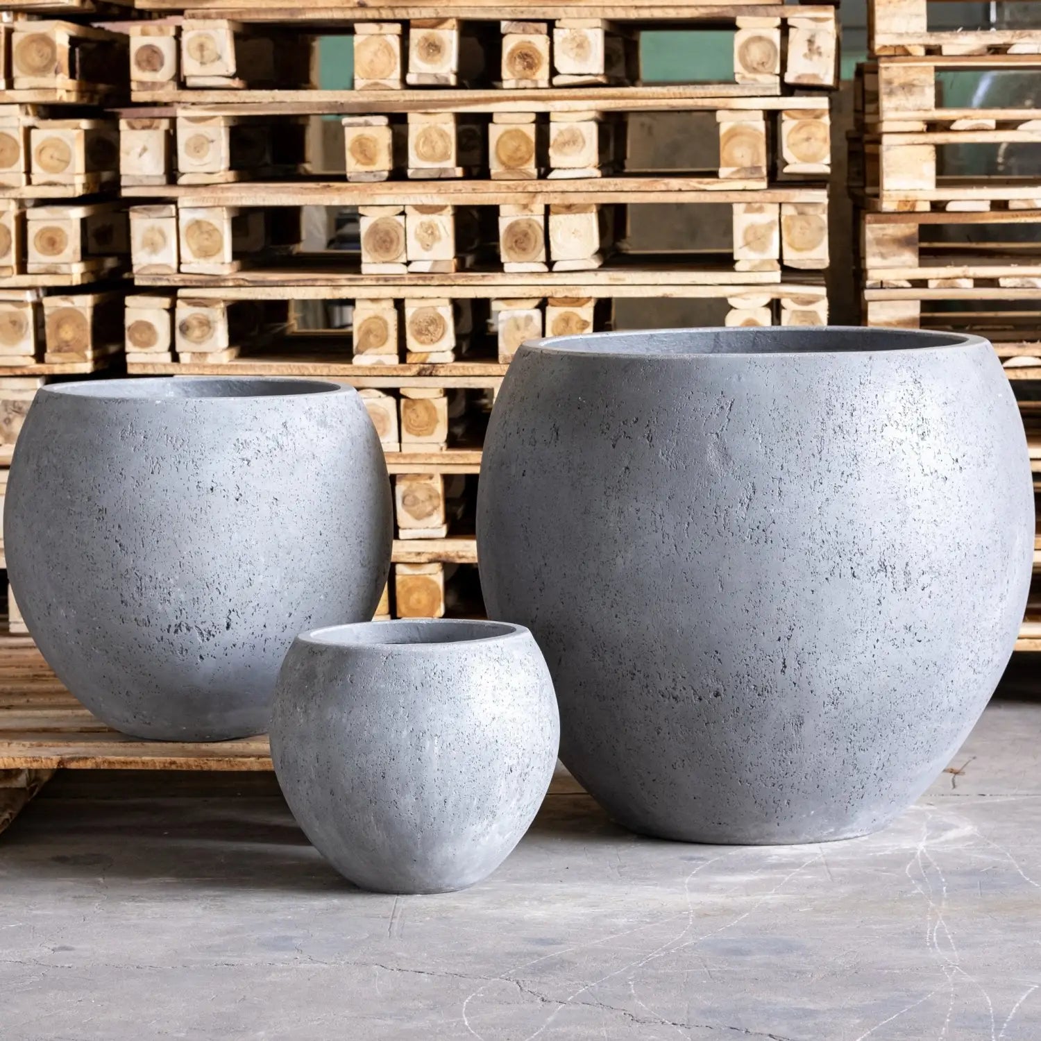 Three gray spherical planters.