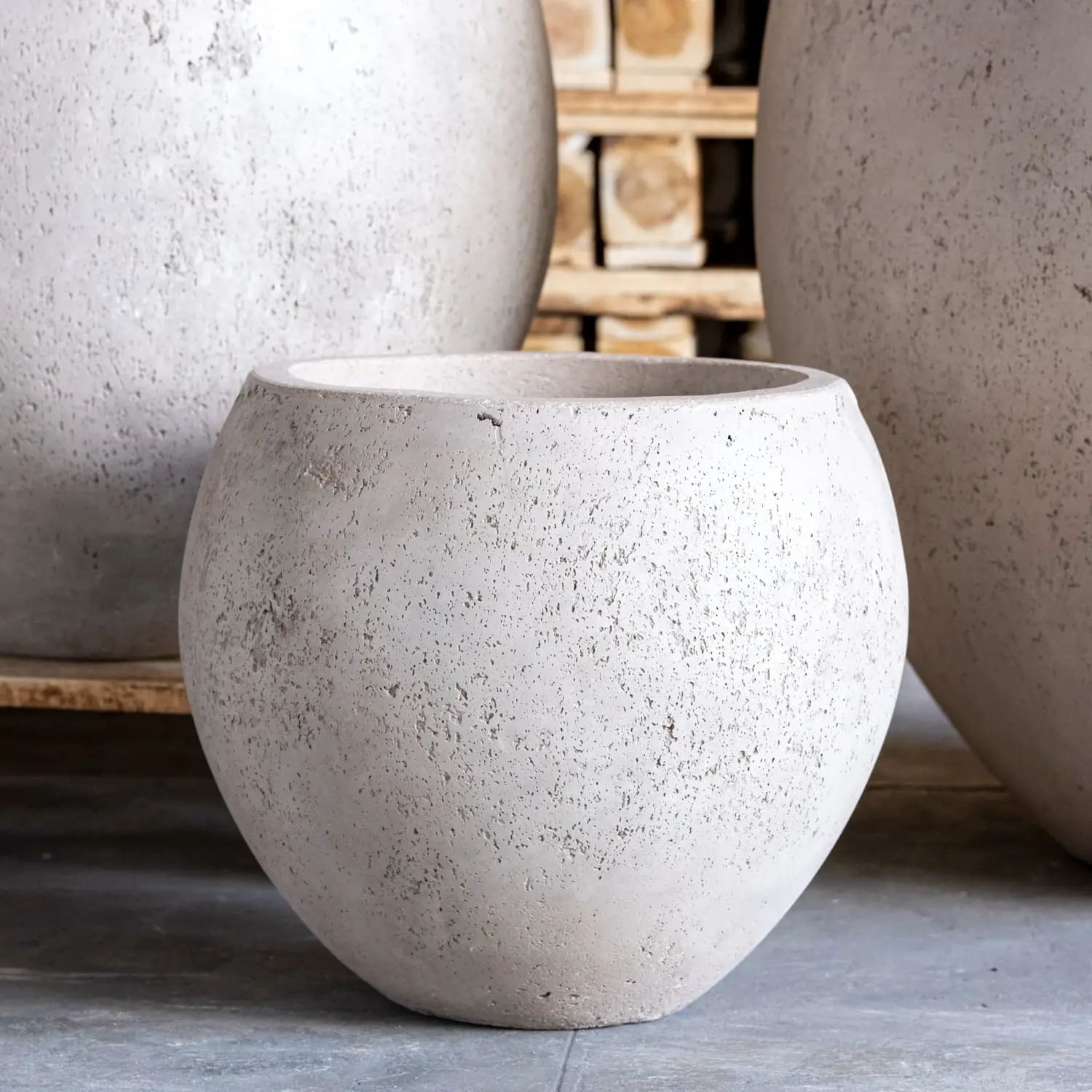 Round, textured, light-colored planter.