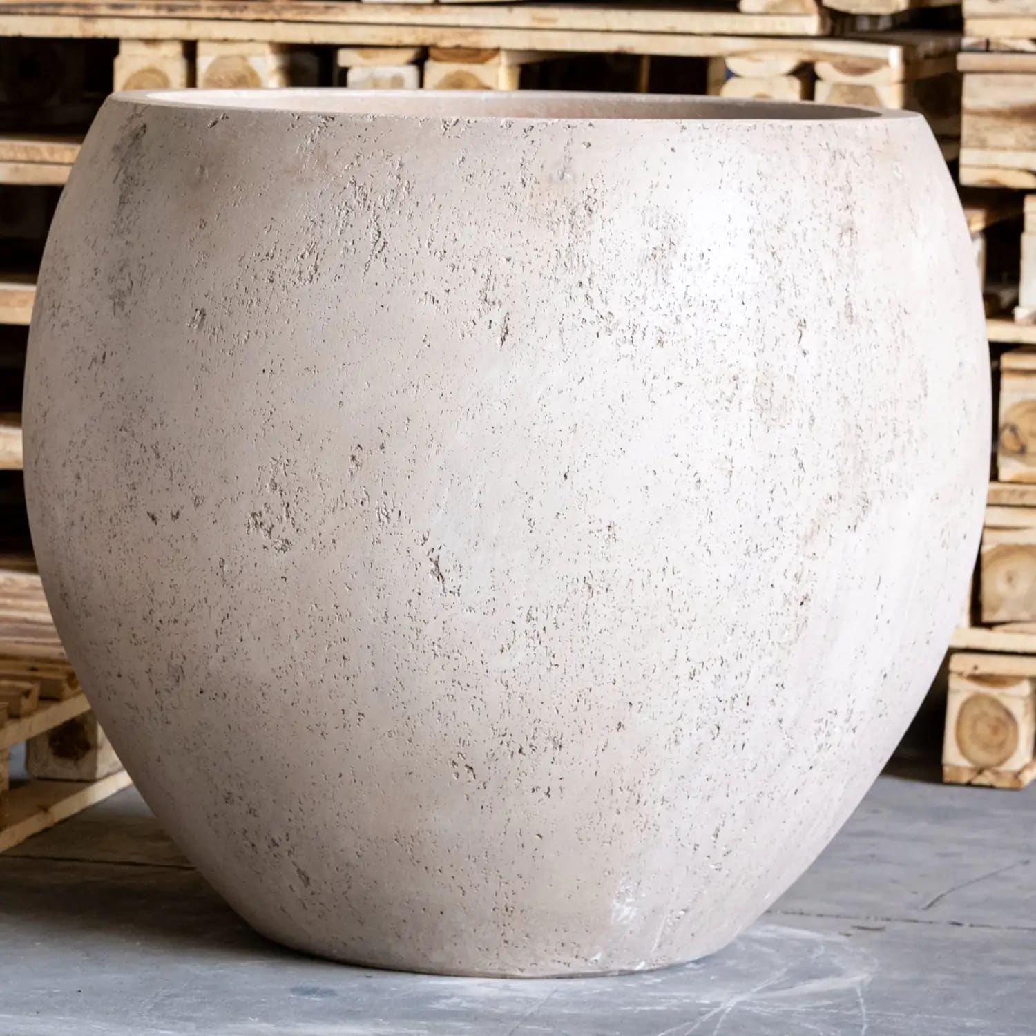 Round, textured, light-colored planter.
