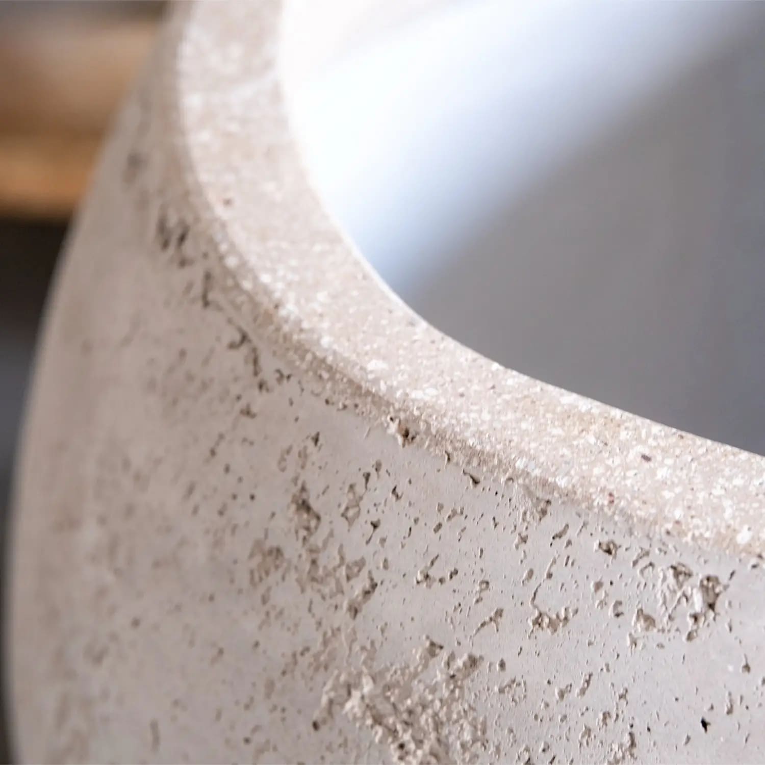 Porous, rounded concrete planter.