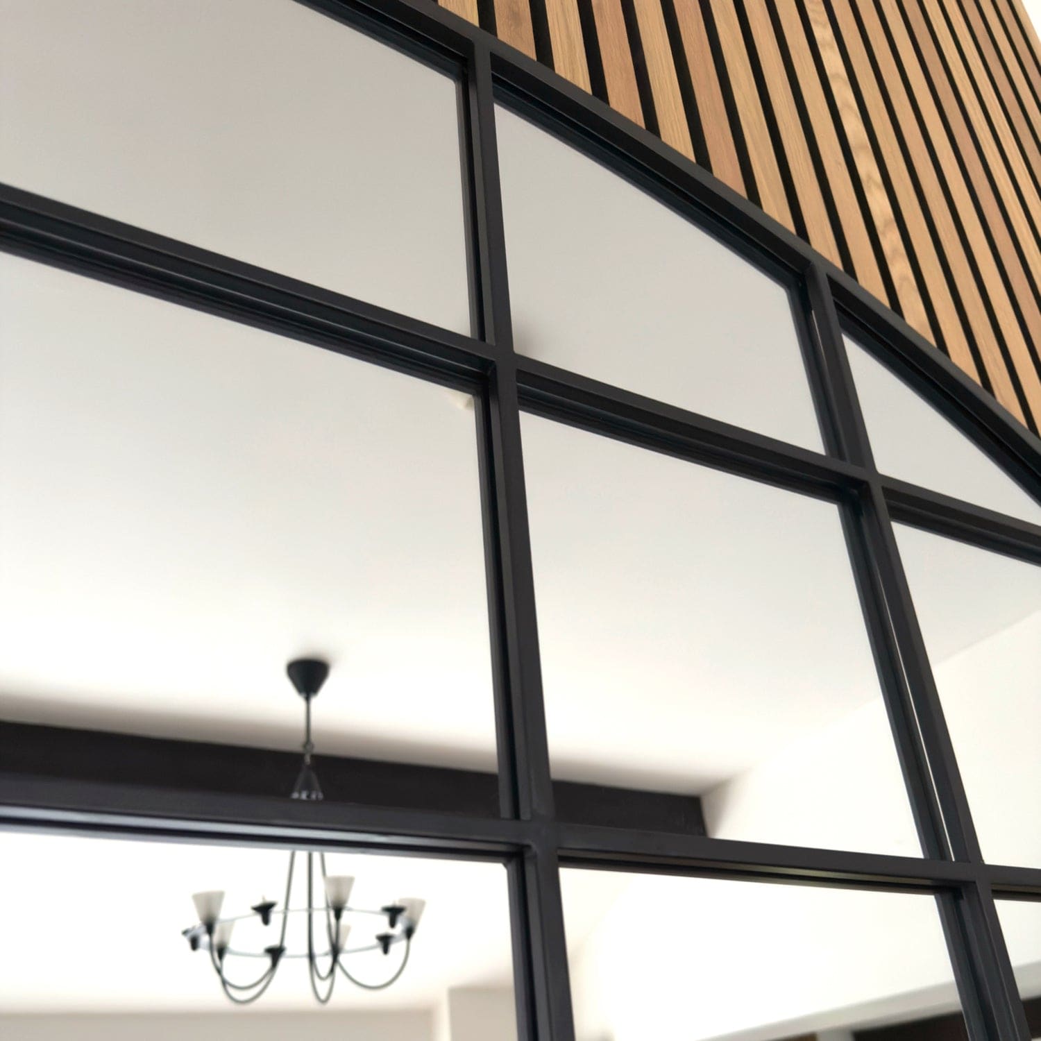 Black-framed window grid with geometric panes.