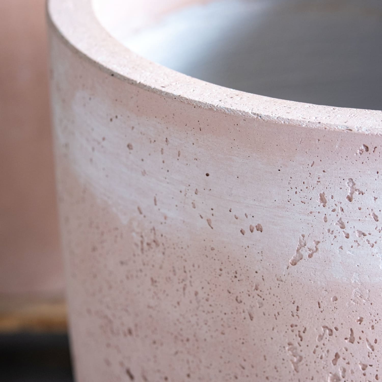 Textured, cylindrical, concrete planter.