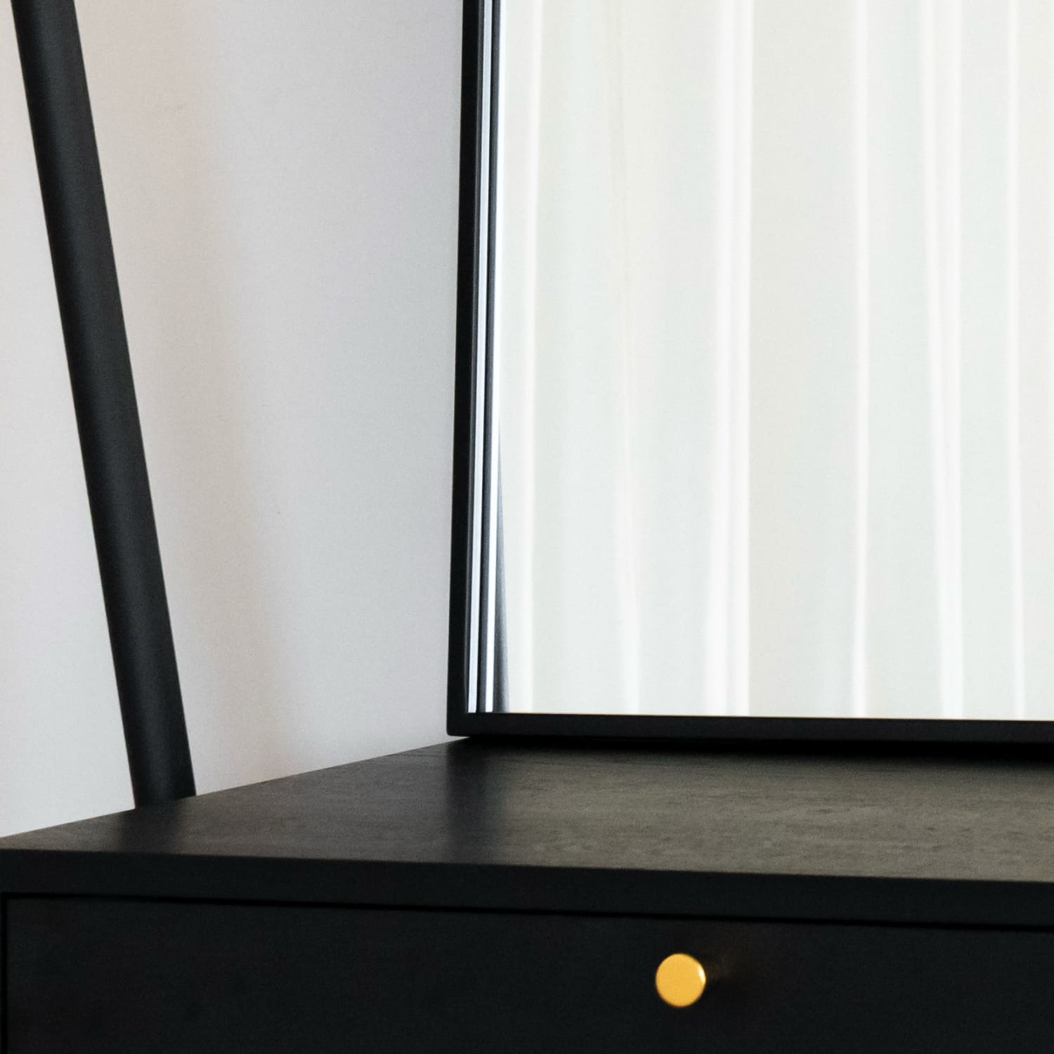 Black desk or table with a yellow knob or handle.