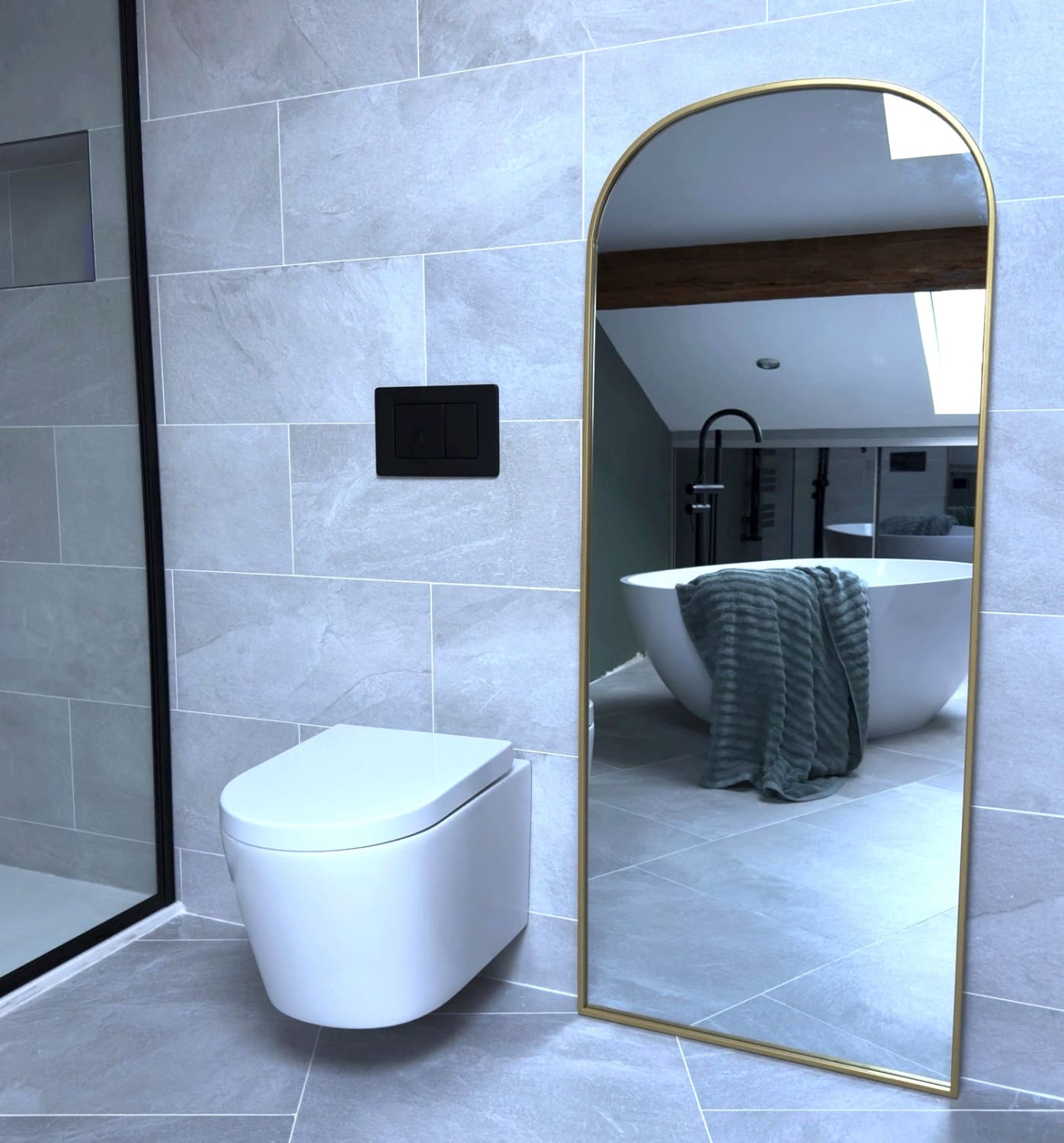 Gold-framed arched mirror.