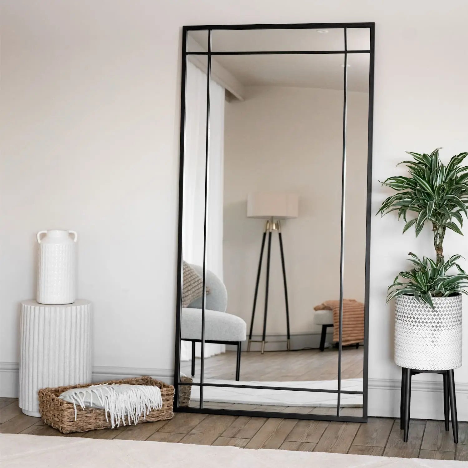 Tall, black-framed mirror with a grid design.