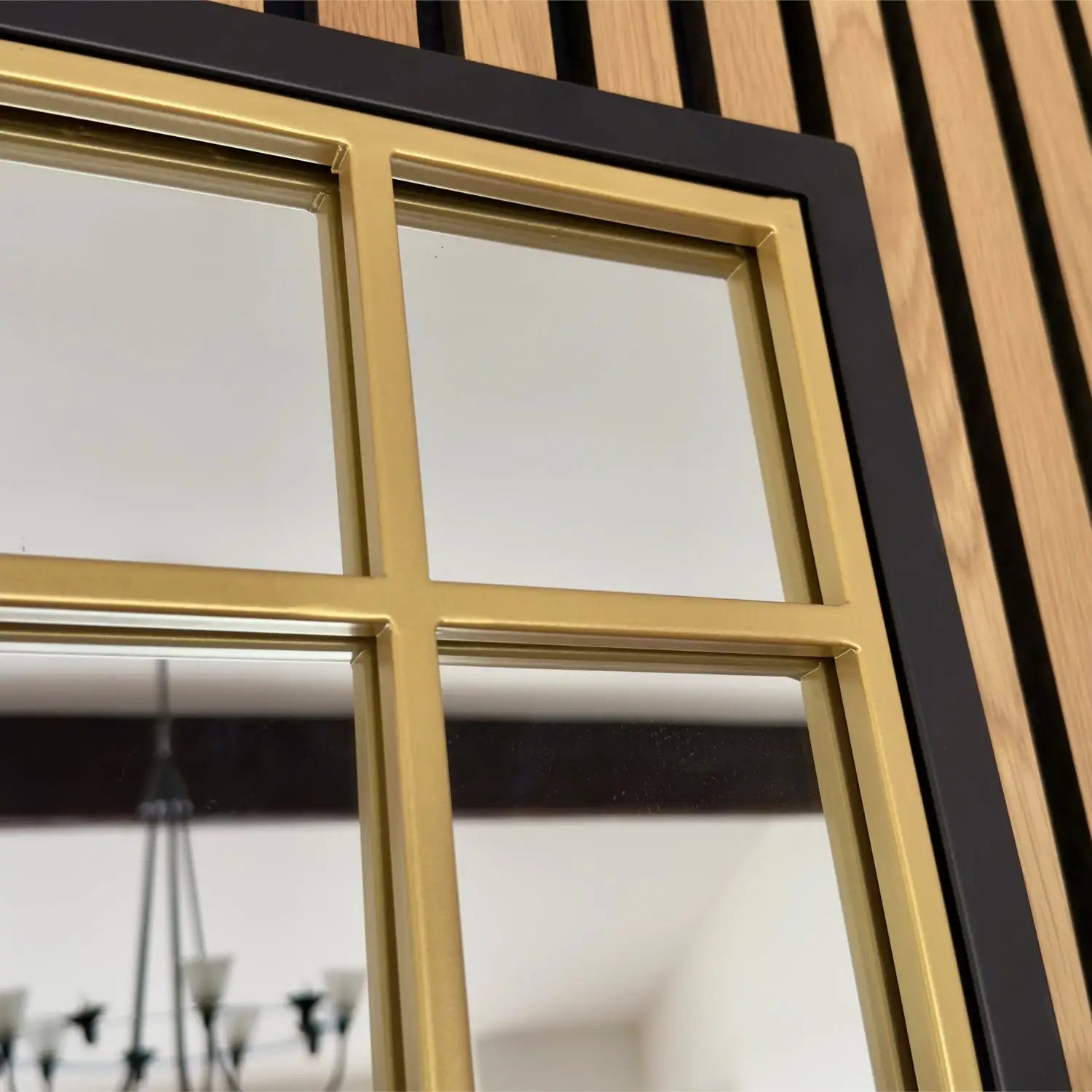 Gold-framed window with black trim and four panes.