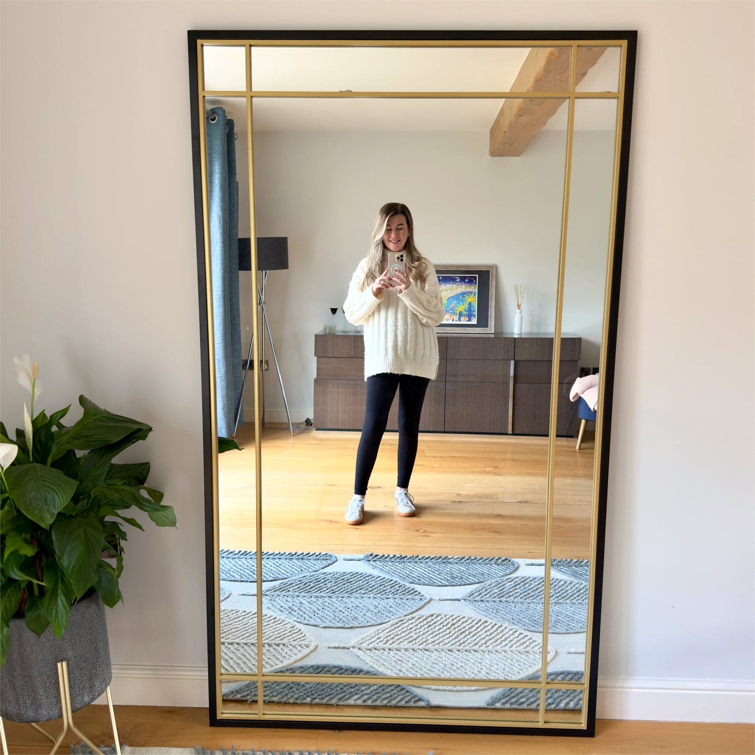 Rectangular black and gold framed mirror.