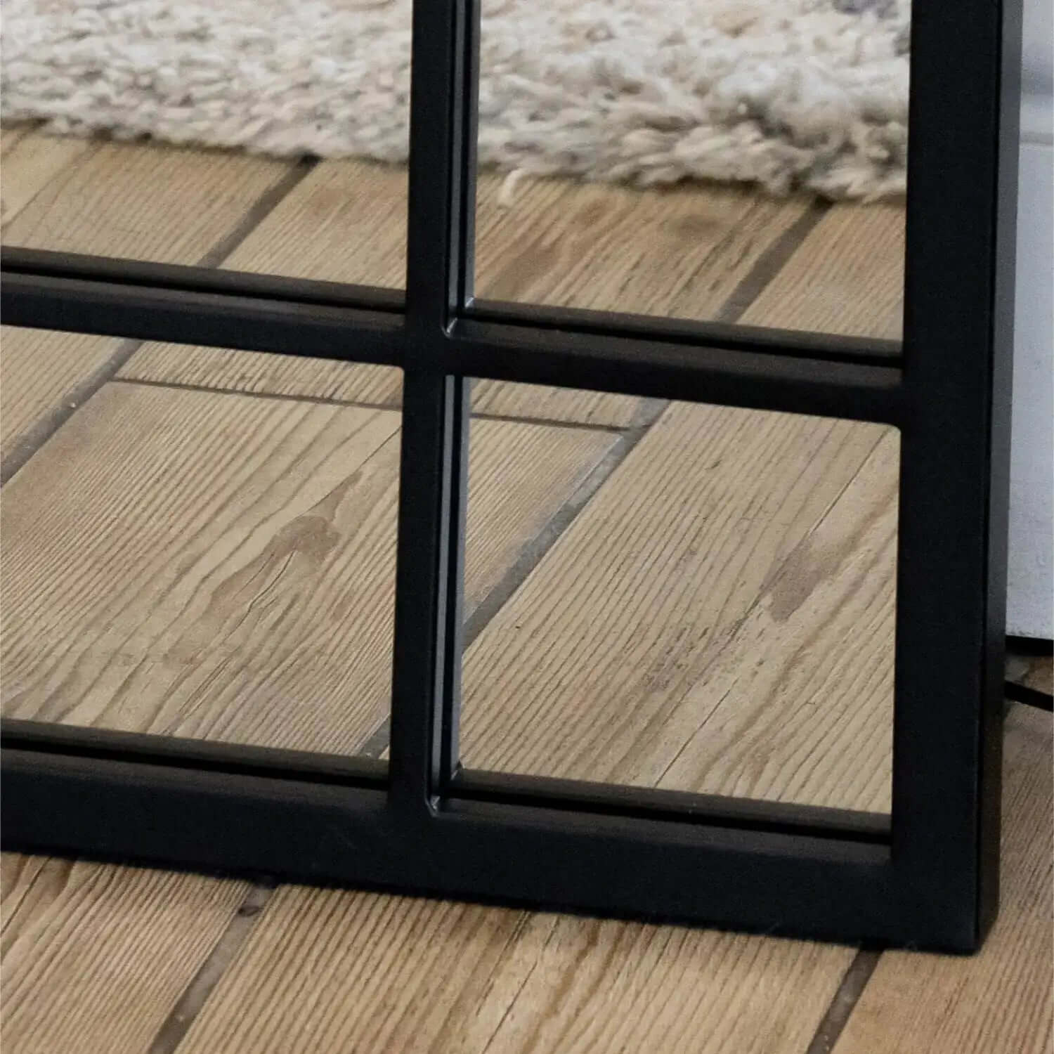 Black metal window frame with paned glass dividers.