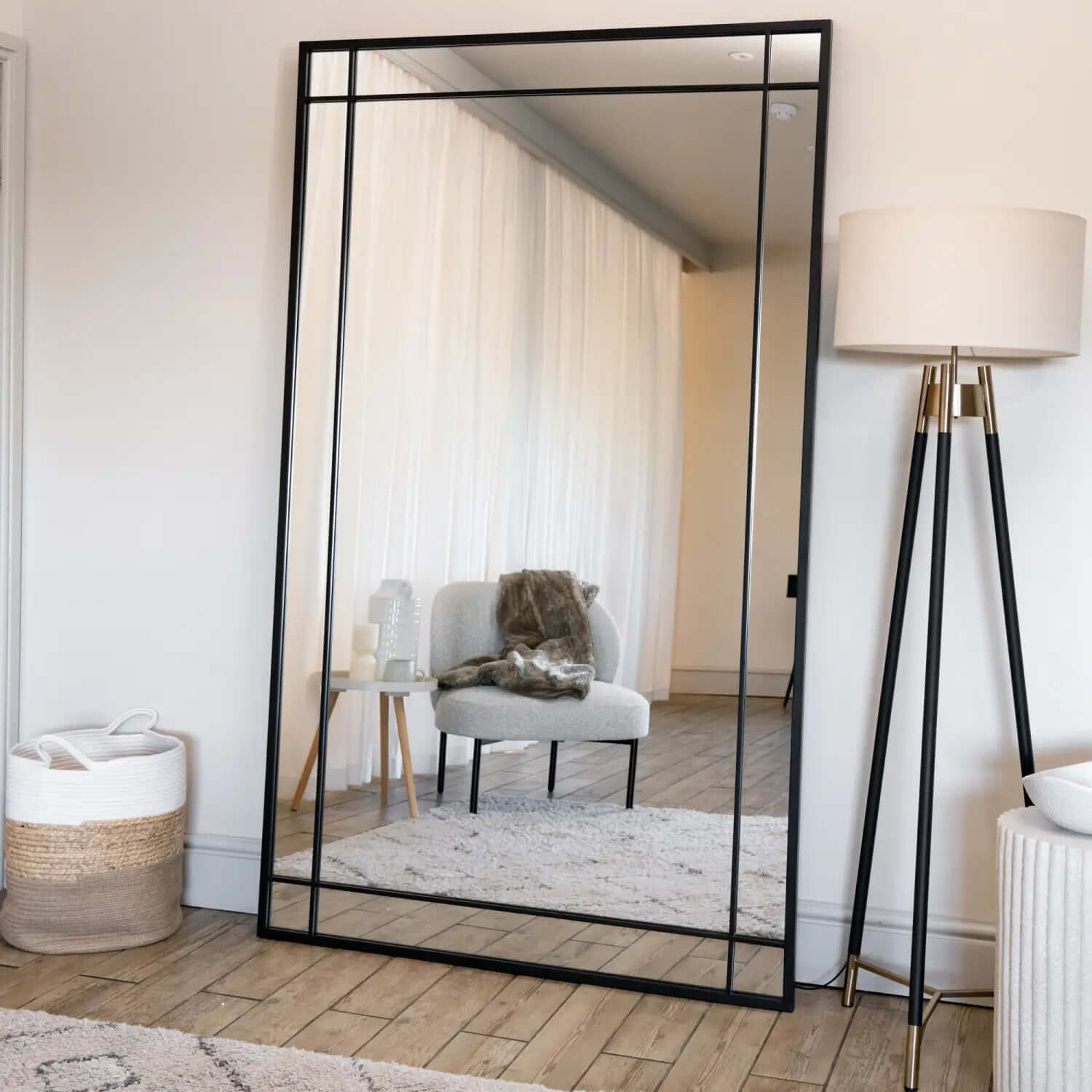 Floor mirror with a black metal frame.