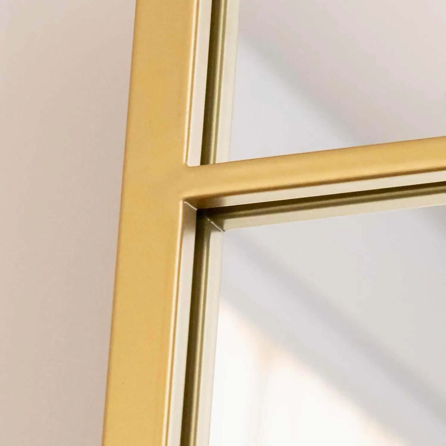 Gold-framed window divider with clean geometric lines.