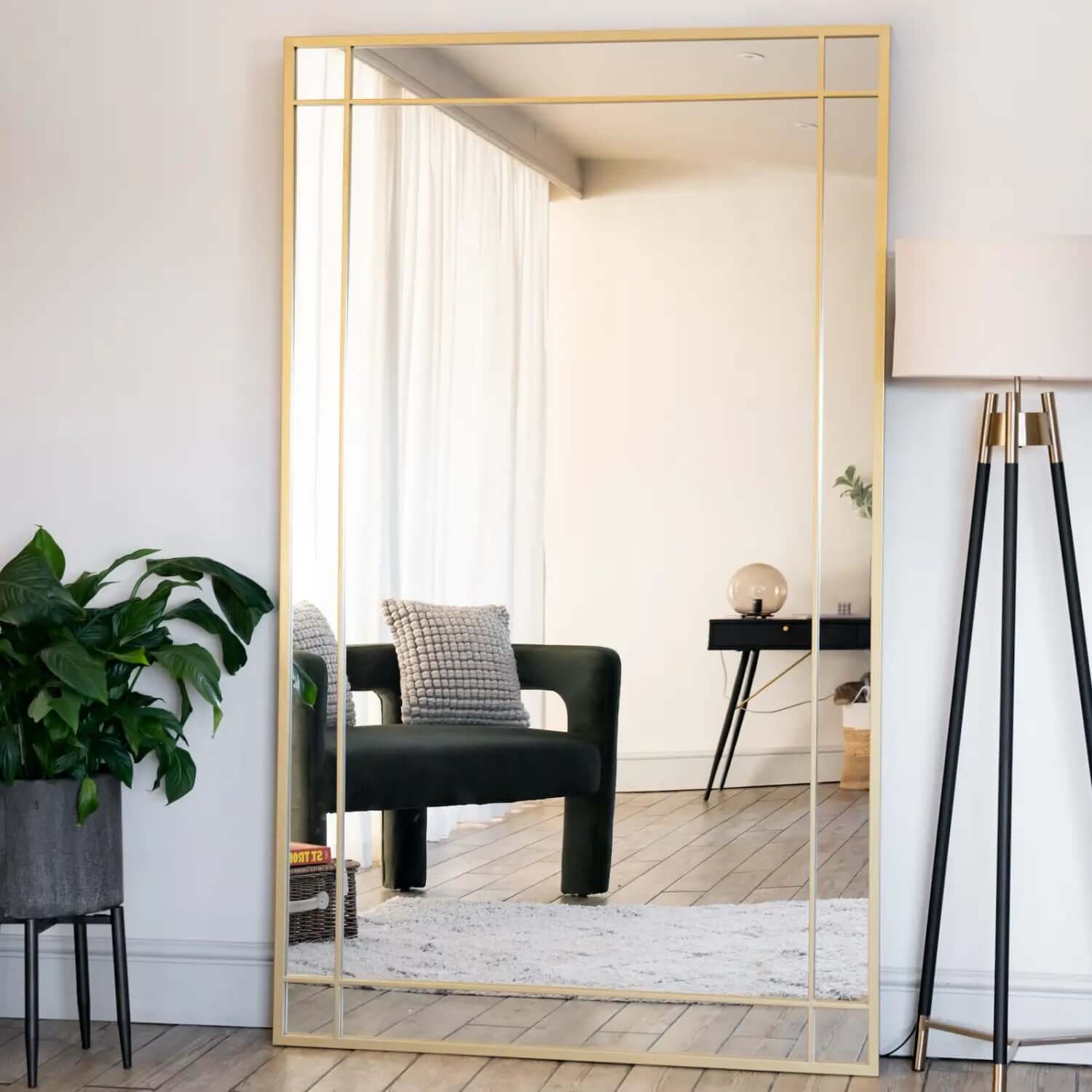 Gold-framed rectangular mirror with geometric border details.