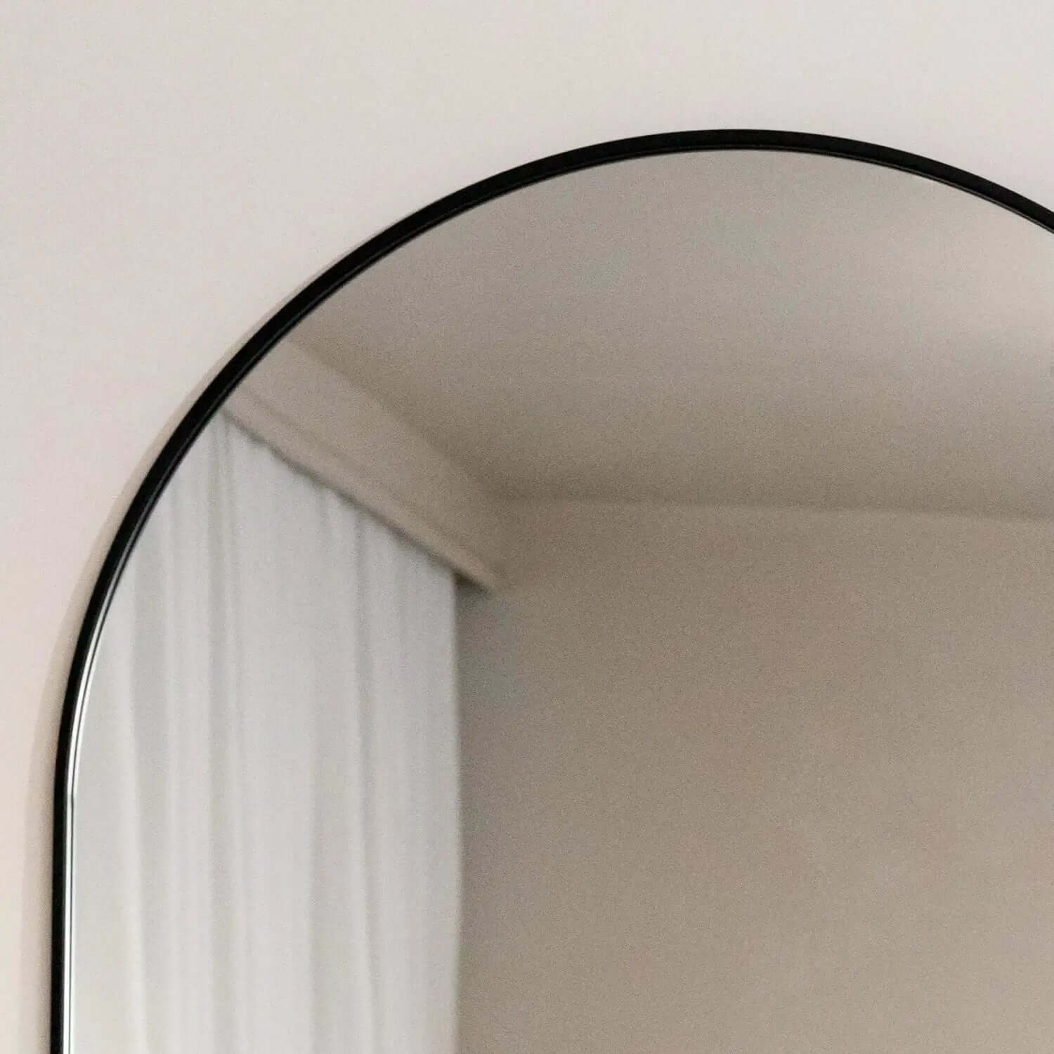 Round mirror with a thin black frame.