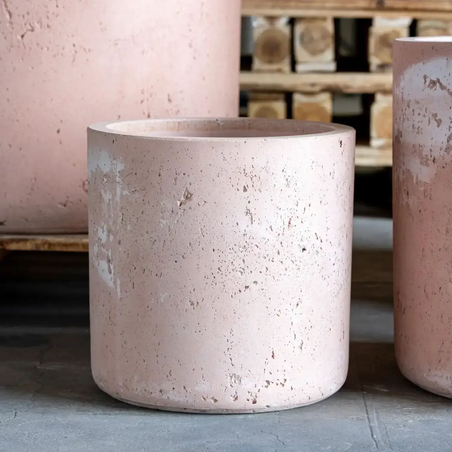 Pink cylindrical concrete planter.