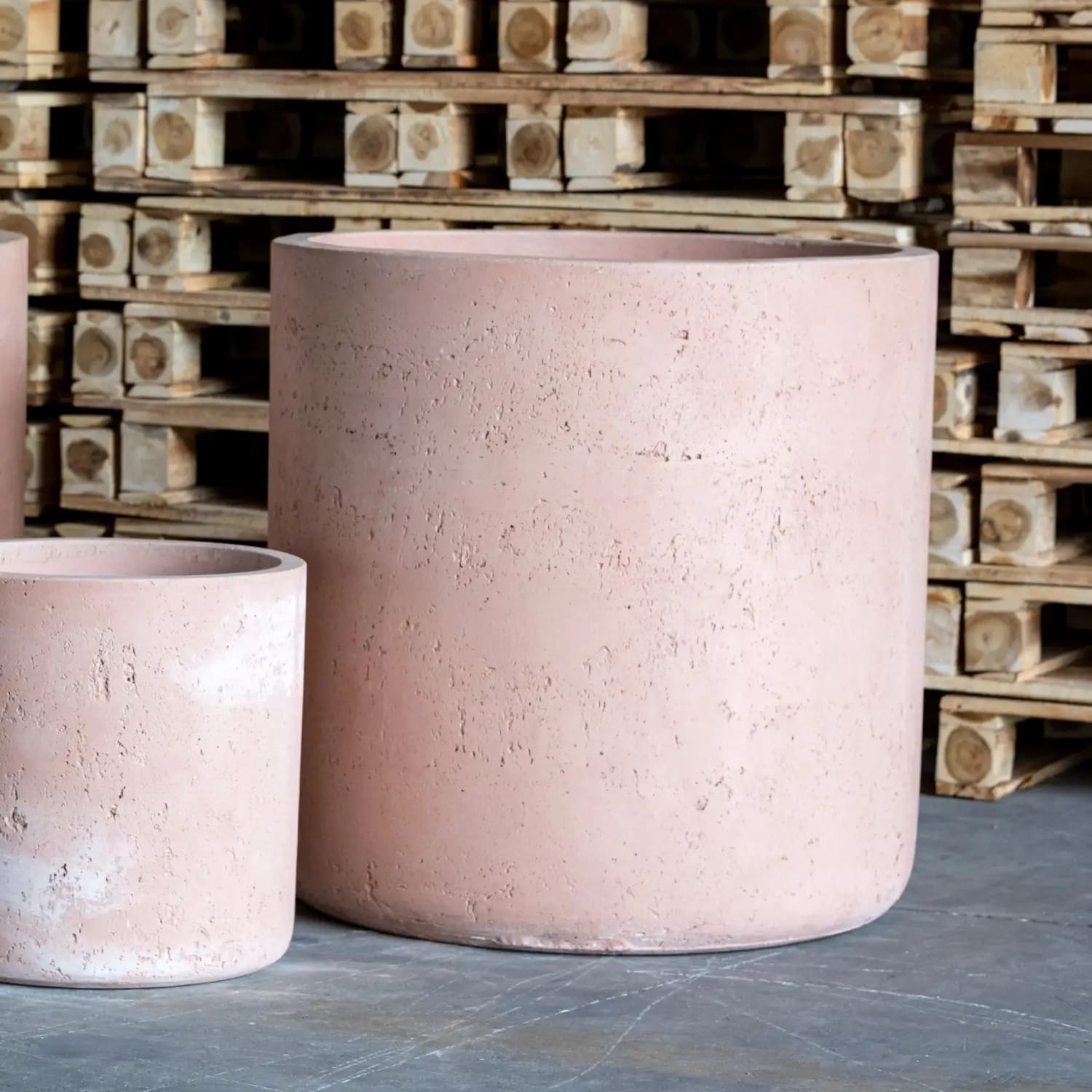 Pink cylindrical concrete planters.