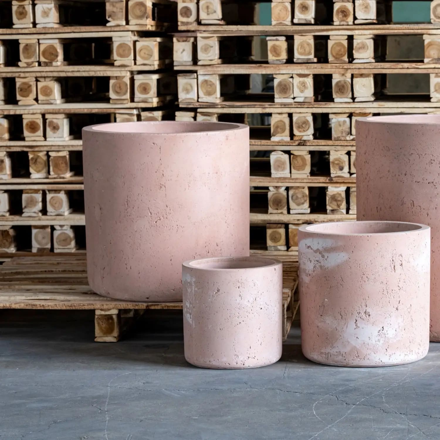 Four pink cylindrical planters.