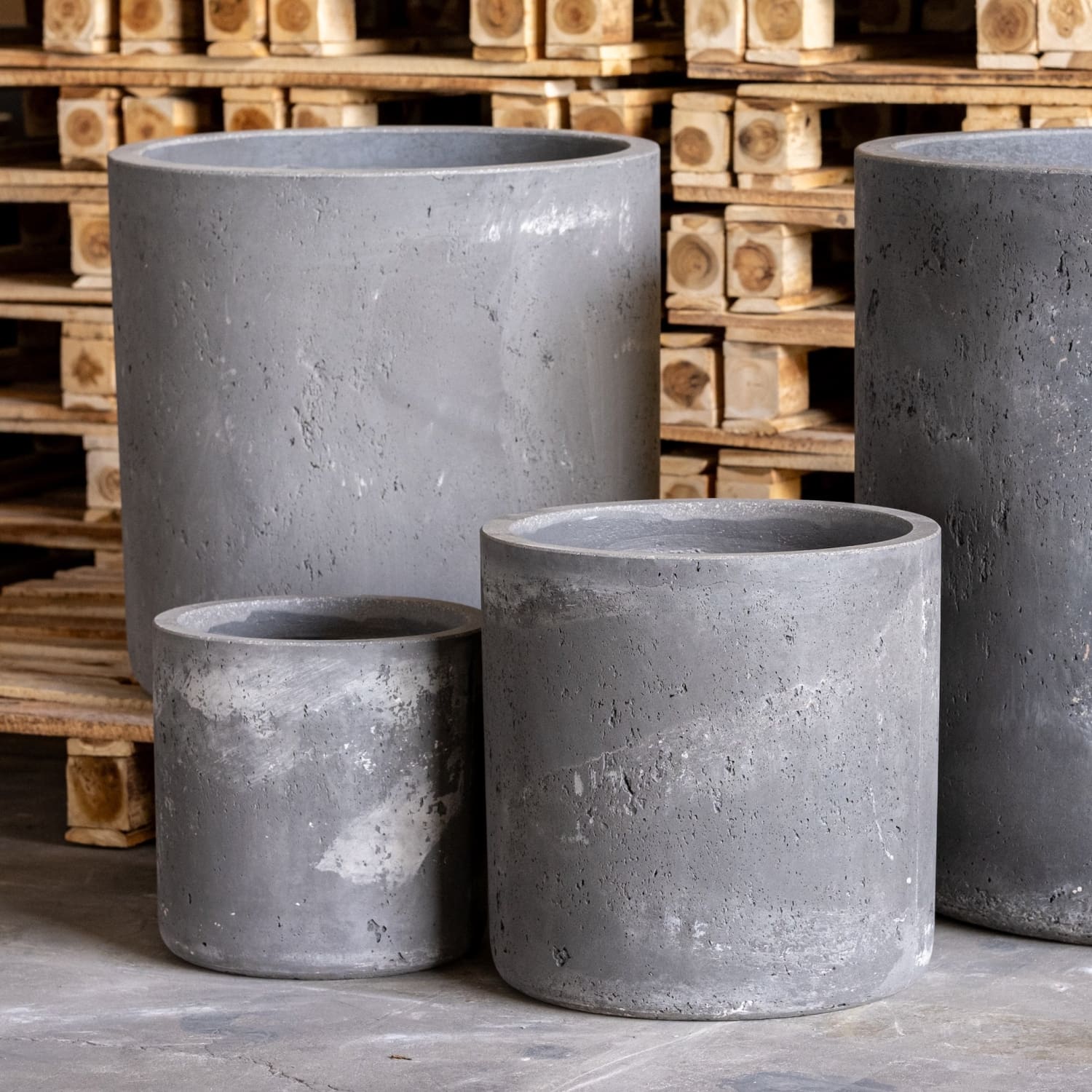 Four gray concrete planters.