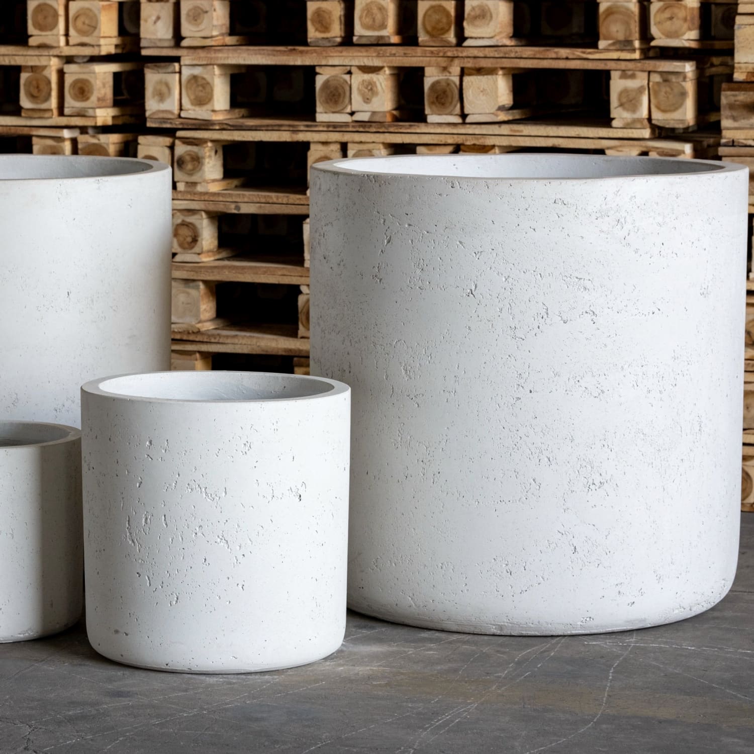 White cylindrical concrete planters.