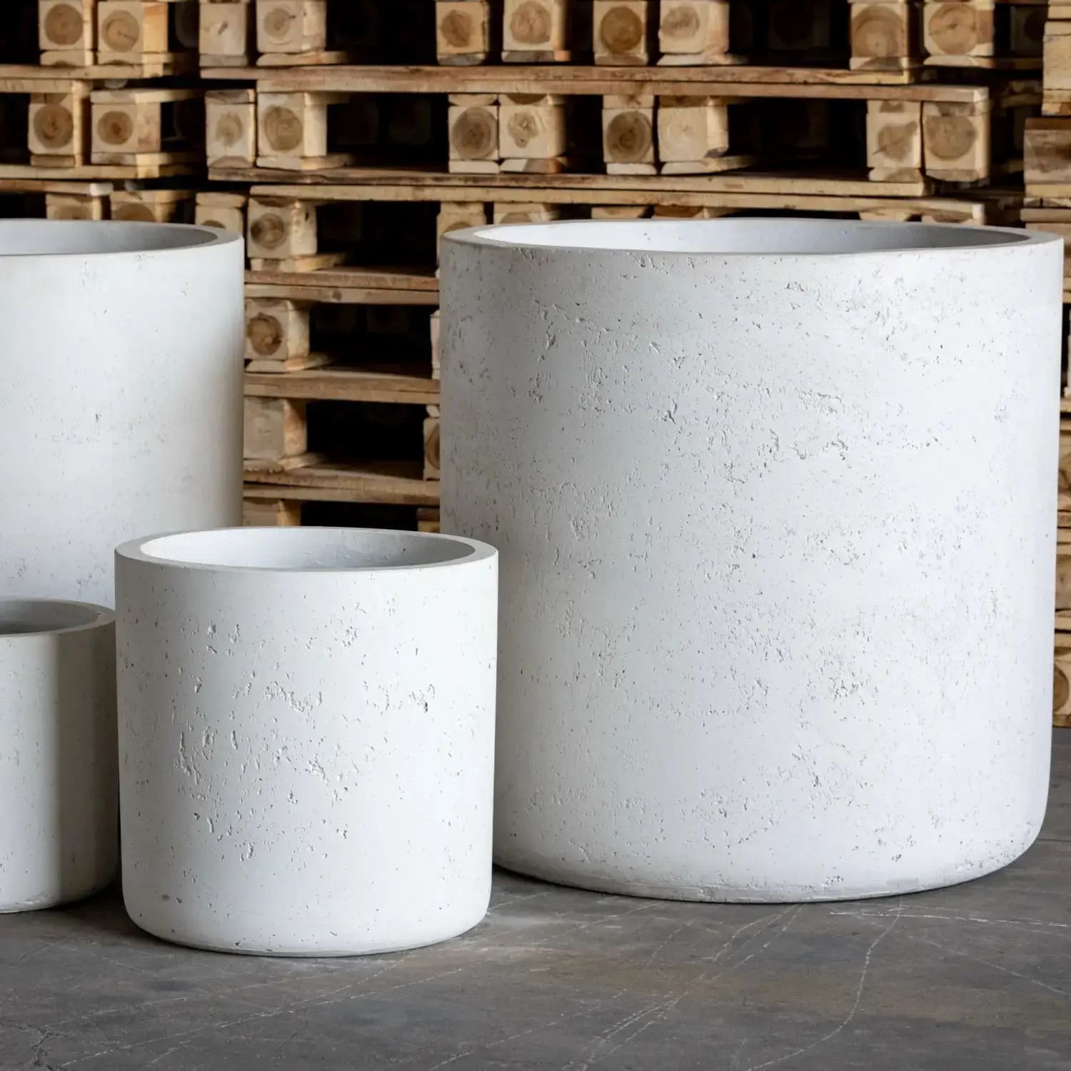 White cylindrical concrete planters.