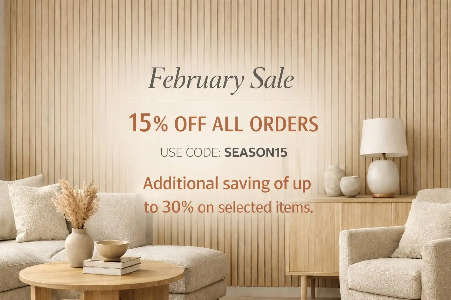 Beige ceramic vase with a slender neck and rounded body, holding dried pampas grass.