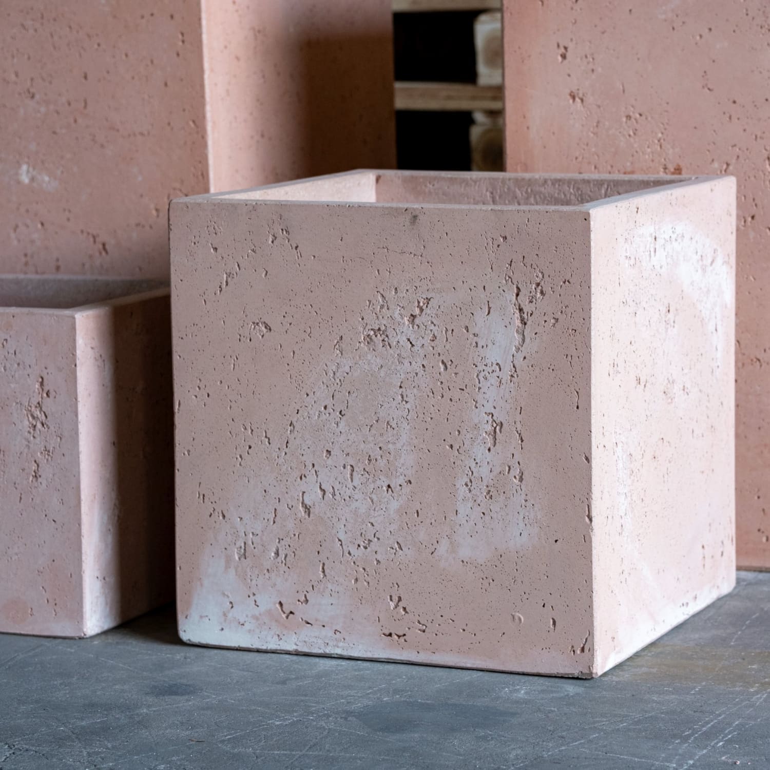 Rough-textured, pinkish-tan, cubic planter.
